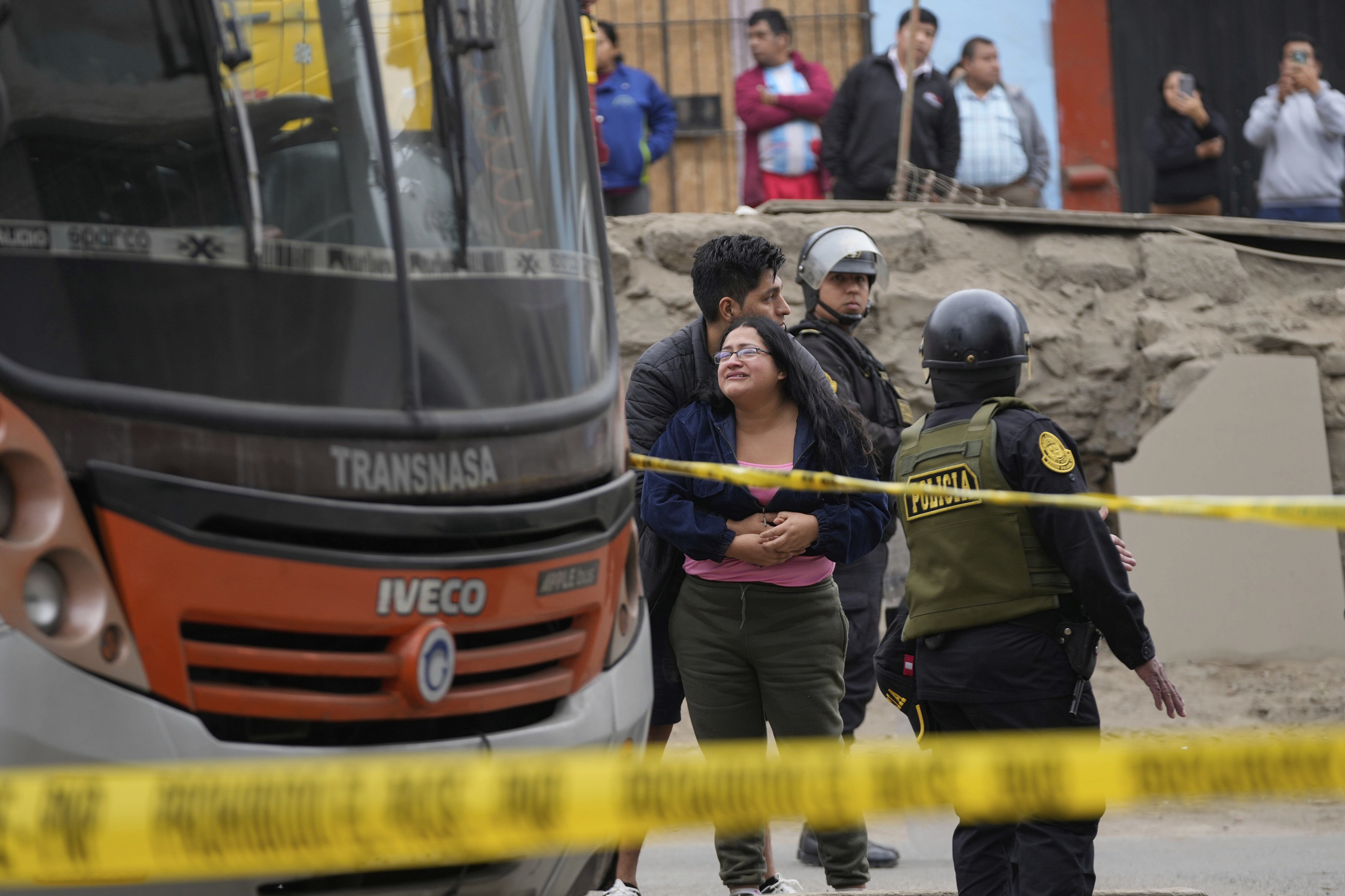 Relatives of bus driver Arturo Ramon cry next the bus where he was killed in the San Juan de Miraflores neighborhood of Lima, Peru, Monday, Sept. 8, 2025. (Martin Mejia - AP)
