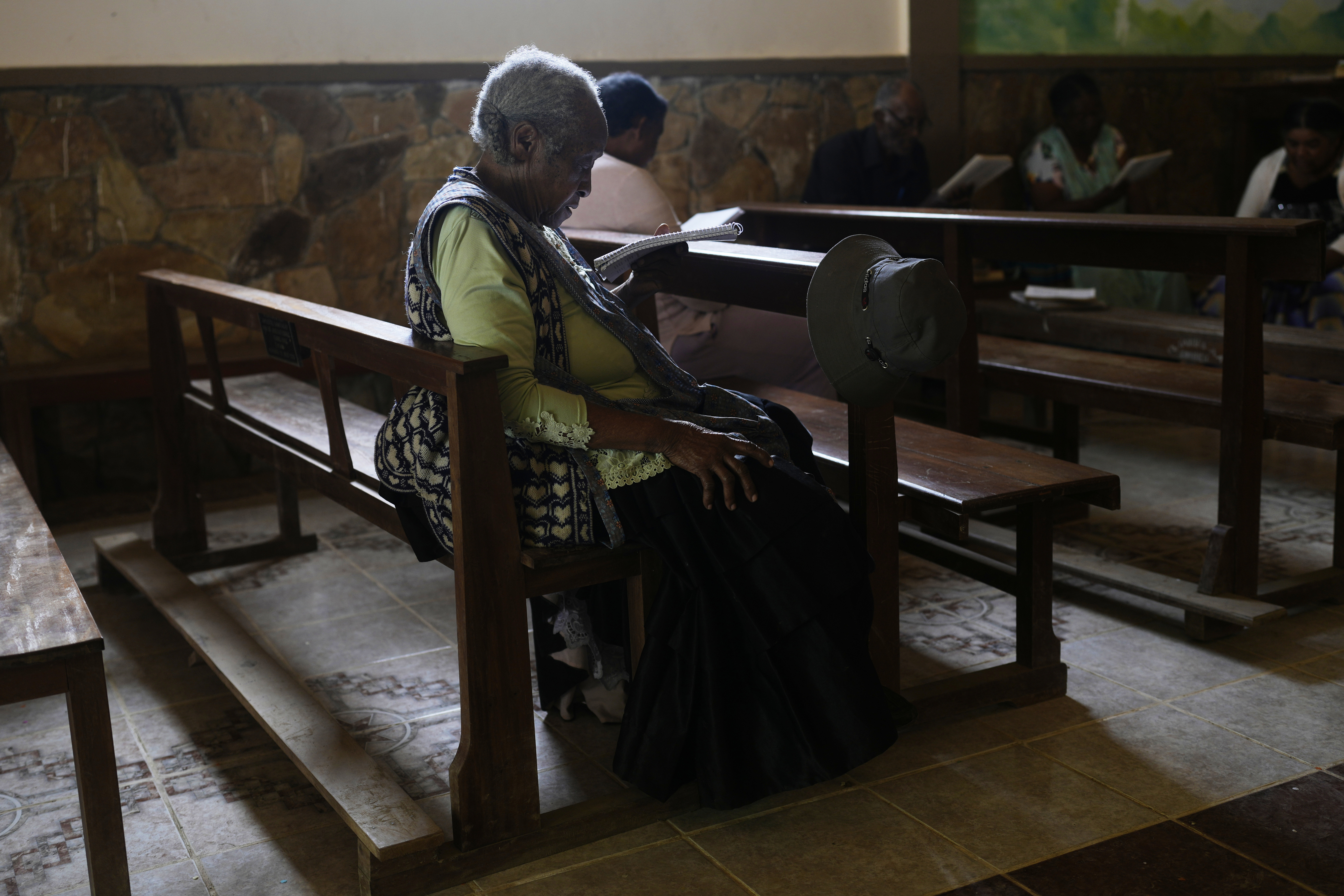 Angelica Larrea, wife of Julio Pinedo, a symbolic leader who is regarded as the king of the Afro-Bolivians, attends a service at the Catholic Church of Tocana, Bolivia, Sunday, Aug. 3, 2025. (Juan Karita - AP)