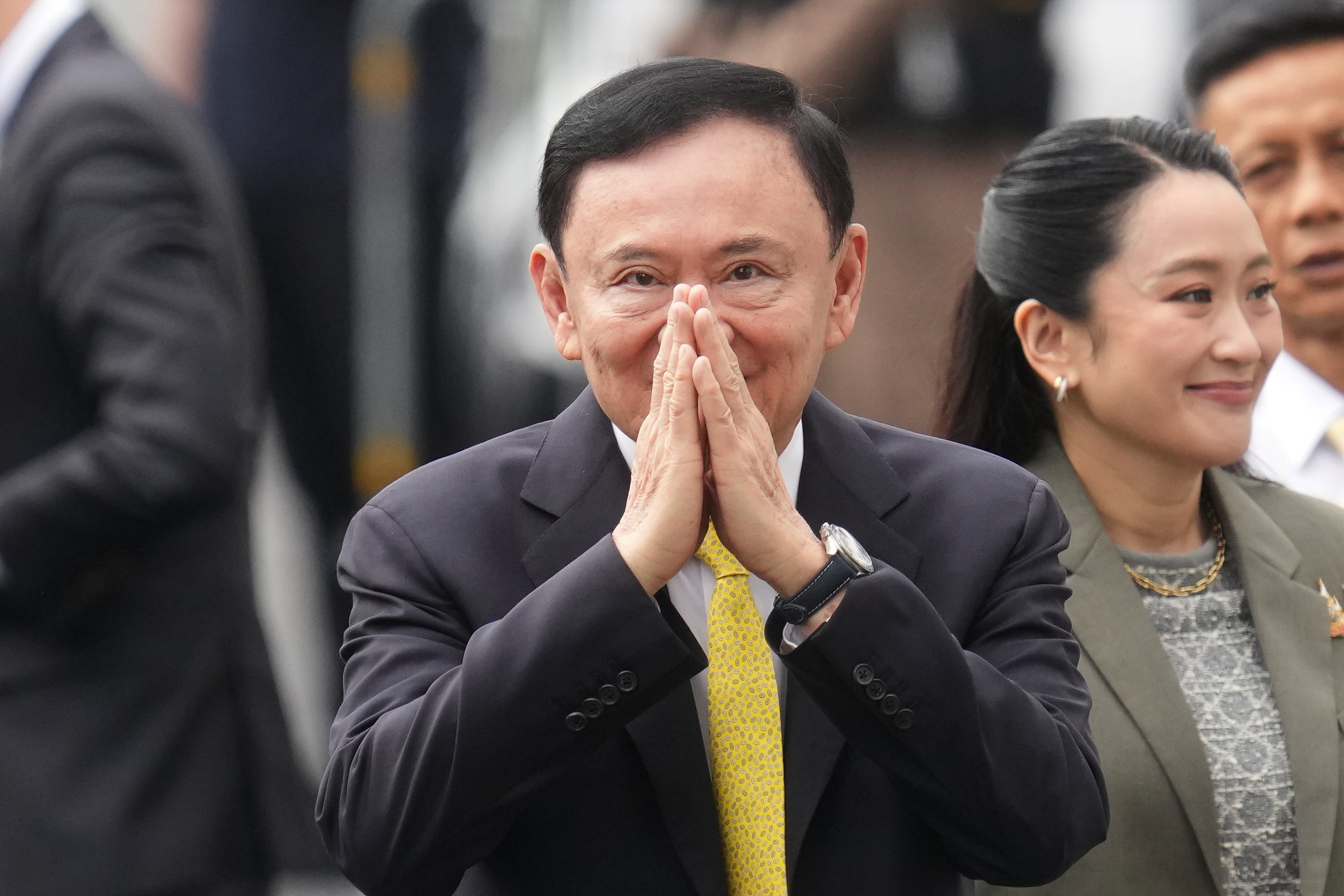 Thailand's former Prime Minister Thaksin Shinawatra, center, and his daughter and former Prime Minister Paetongtarn Shinawatra, right, arrive at Supreme Court in Bangkok, Thailand, Tuesday, Sept. 9, 2025. (Sakchai Lait - AP)