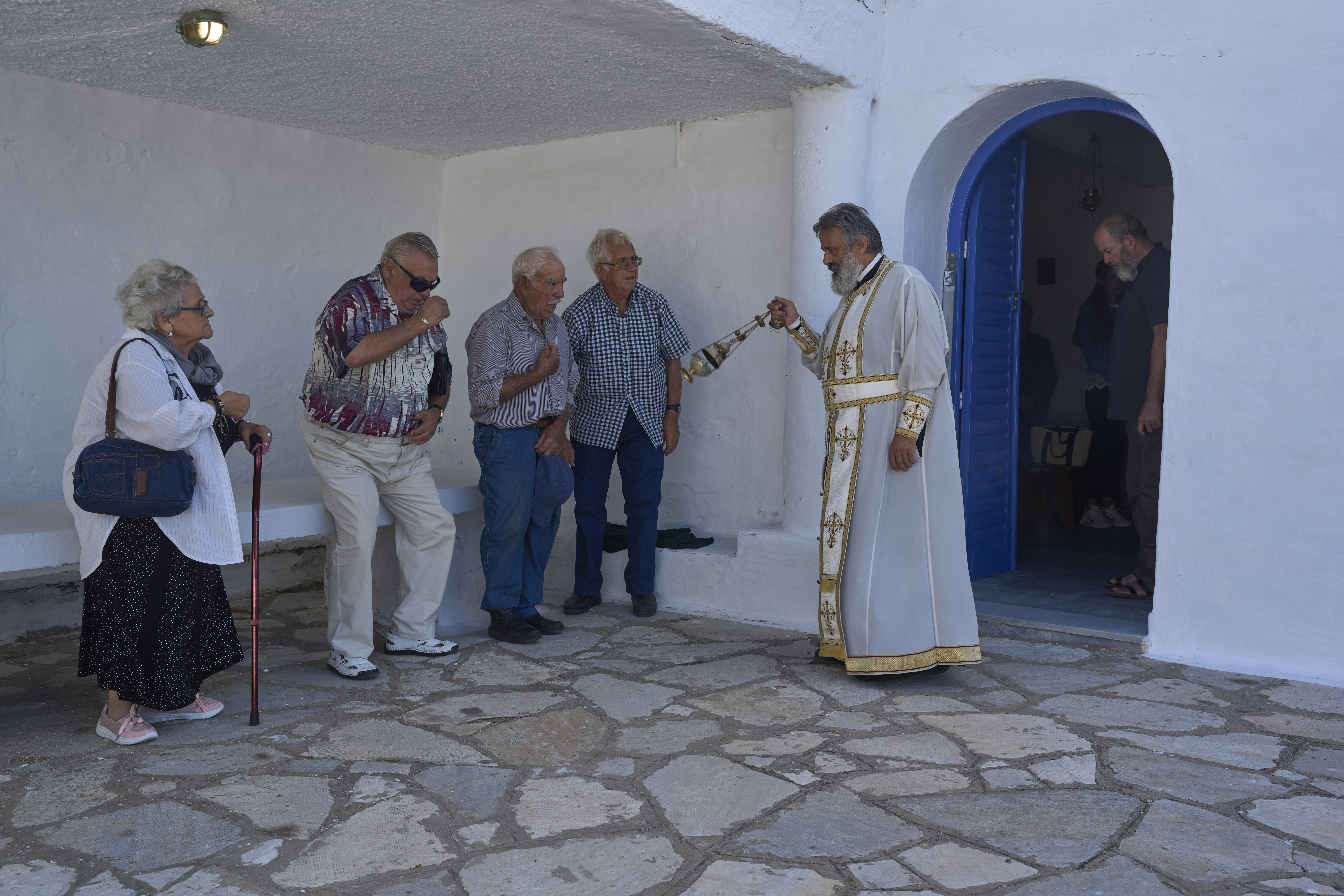 An Orthodox priest swings a censer during a liturgy at the family-owned Agios Sostis chapel on the island of Tinos, Greece, Monday, Sept. 8, 2025. (Petros Giannakouris - AP)