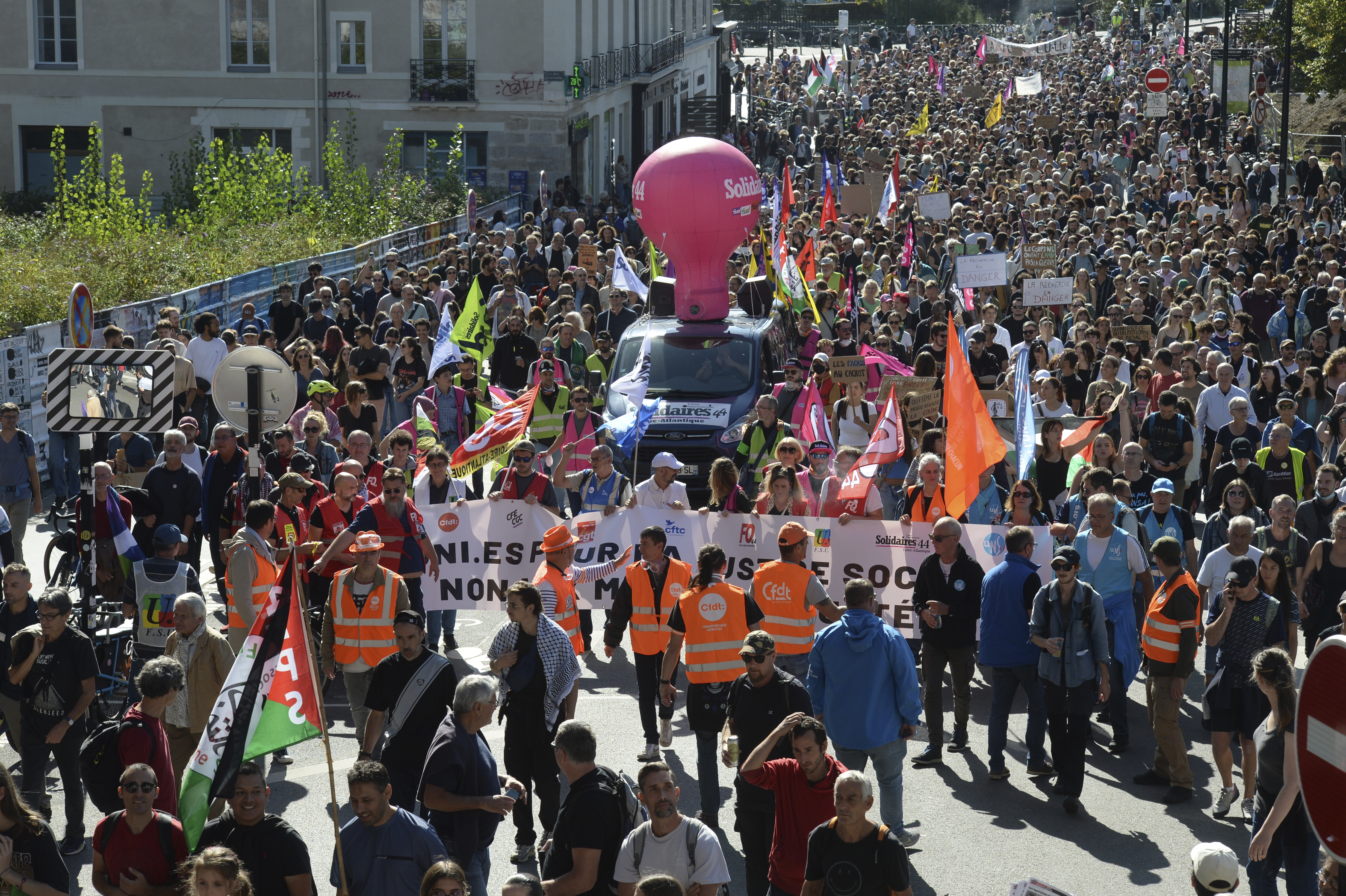 Demonstrators march during a protest called by major trade unions to oppose budget cuts, in Nantes, western France, Thursday, Sept. 18, 2025. (Mathieu Pattier - AP)