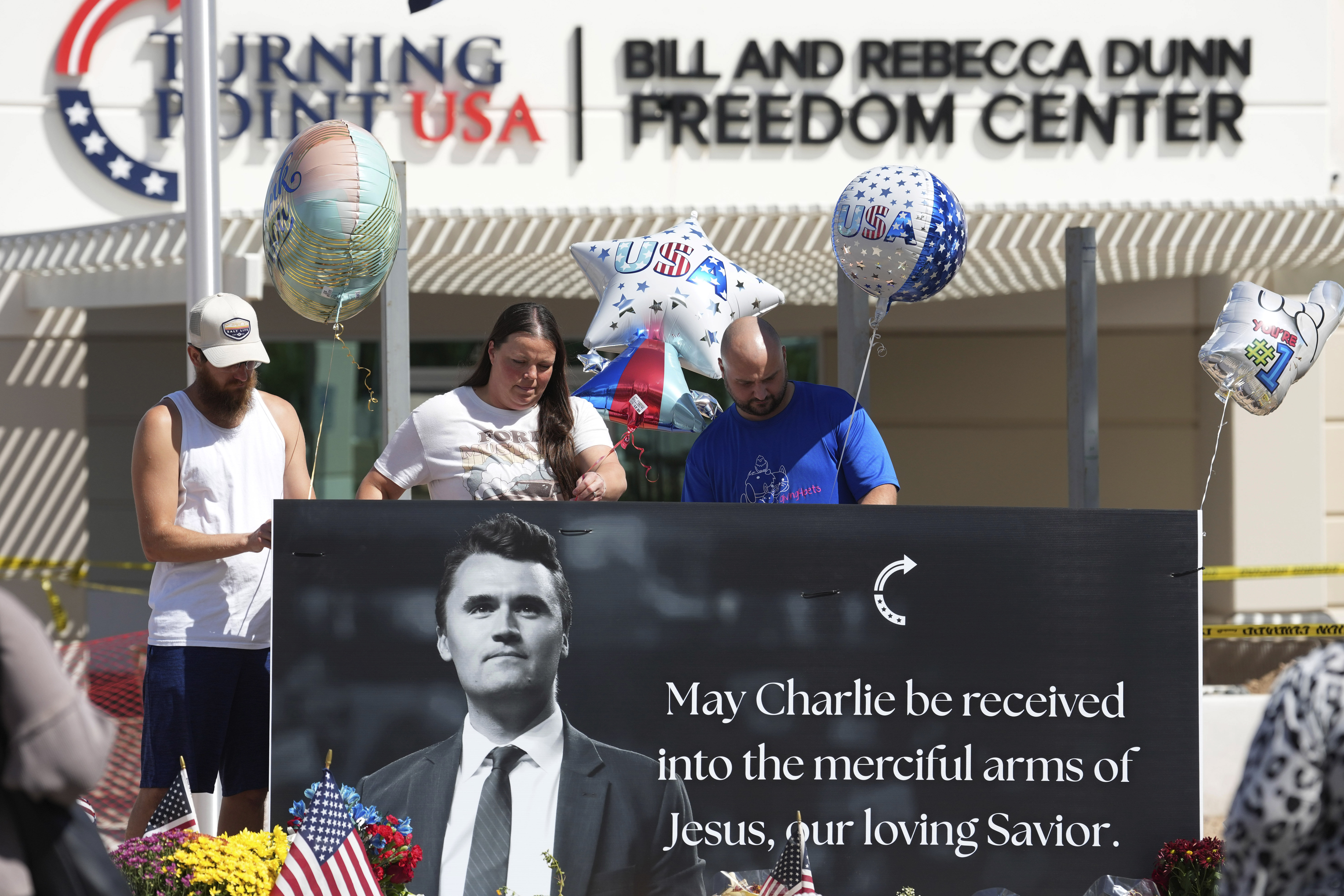 Well-wishers add balloons to a makeshift memorial set up at Turning Point USA headquarters after the shooting death at a Utah college on Wednesday of Charlie Kirk, the 31-year-old founder and CEO of the organization, Thursday, Sept. 11, 2025, in Phoenix. (Ross D. Franklin - AP)