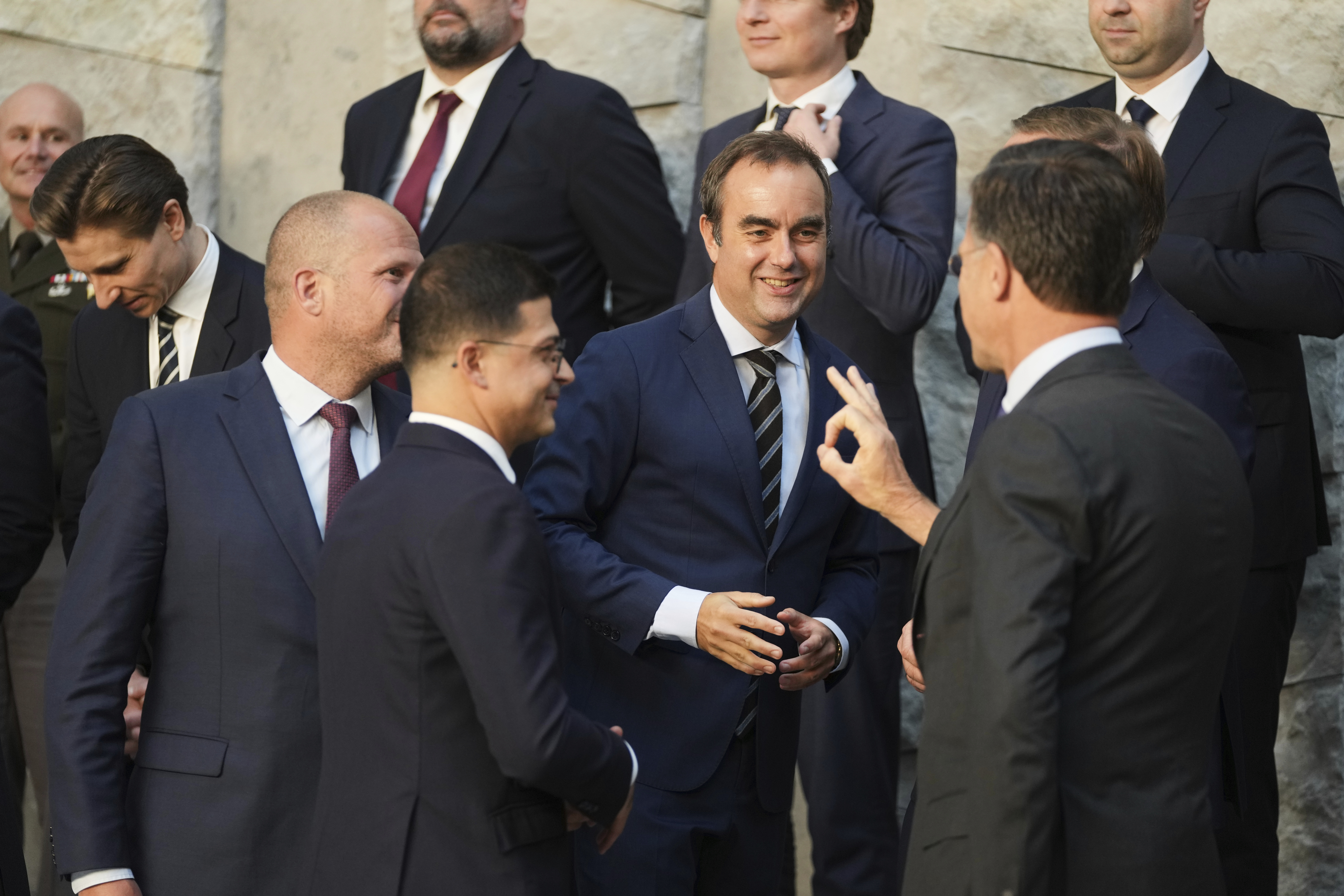 FILE - French Defense Minister Sebastien Lecornu, center, speaks with NATO Secretary General Mark Rutte, second right, during a group photo of NATO defense ministers at NATO headquarters in Brussels, June 5, 2025. (Virginia Mayo - AP)
