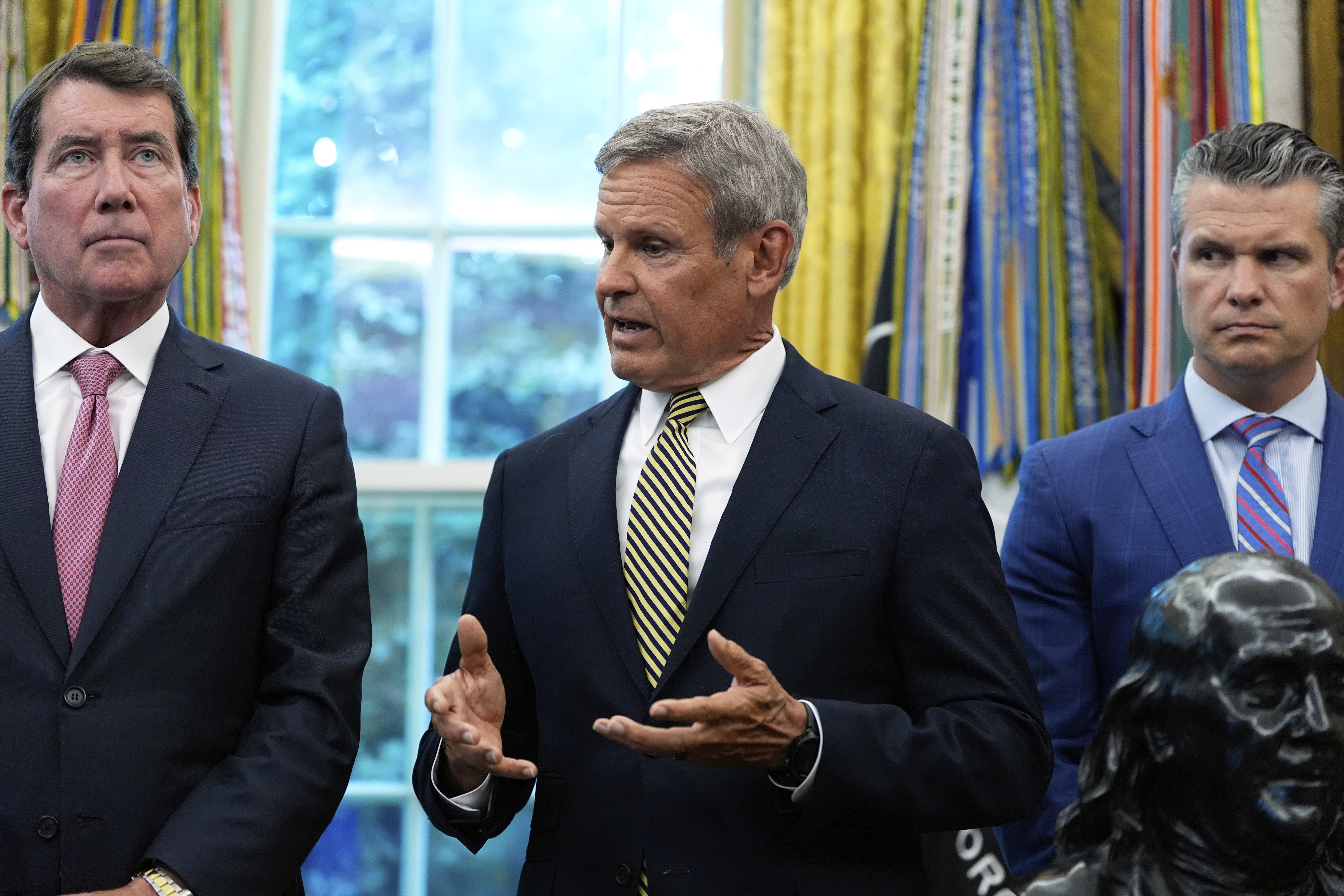 Tennessee Gov. Bill Lee speaks as Sen. Bill Hagerty, R-Tenn., left, and Defense Secretary Pete Hegseth listen during a memorandum singing with President Donald Trump in the Oval Office of the White House, Monday, Sept. 15, 2025, in Washington. (Alex Brandon - AP)