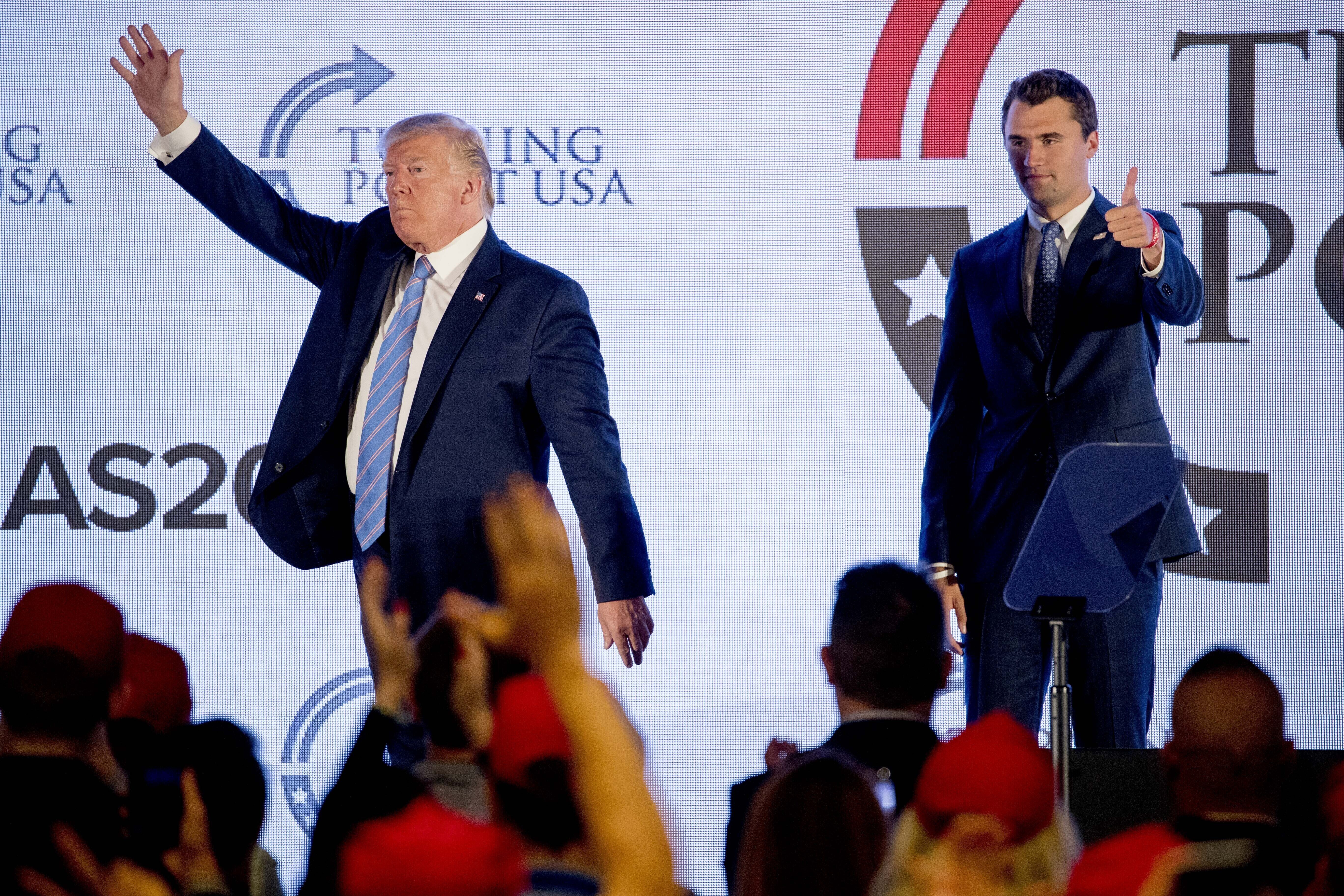 FILE - President Donald Trump is joined on stage with Turning Point USA Founder Charlie Kirk as he finishes speaking at the Marriott Marquis in Washington, July 23, 2019. (Andrew Harnik - AP)