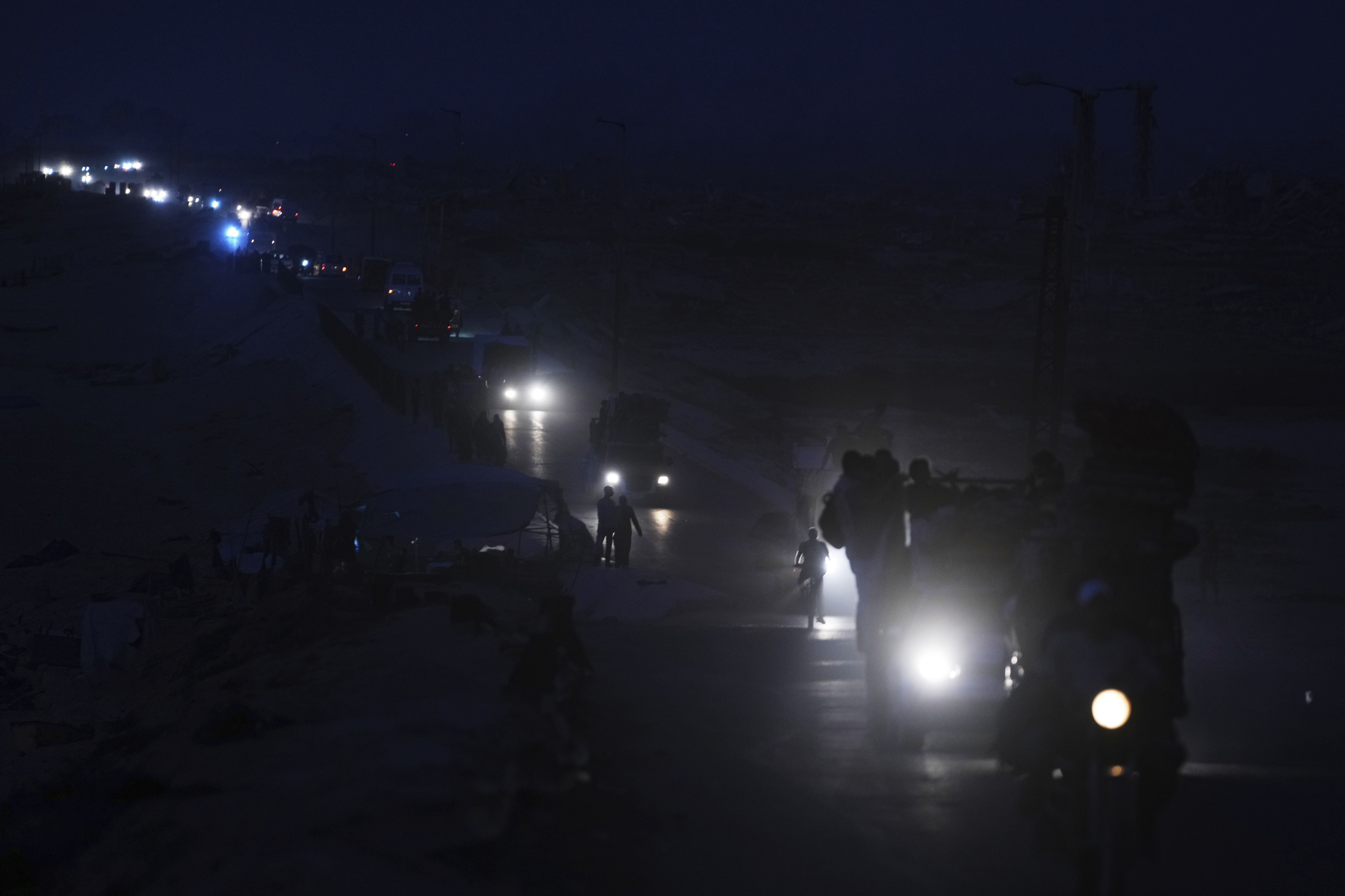 Displaced Palestinians fleeing northern Gaza carry their belongings along the coastal road toward southern Gaza, Saturday, Sept. 6, 2025. (Jehad Alshrafi - AP)