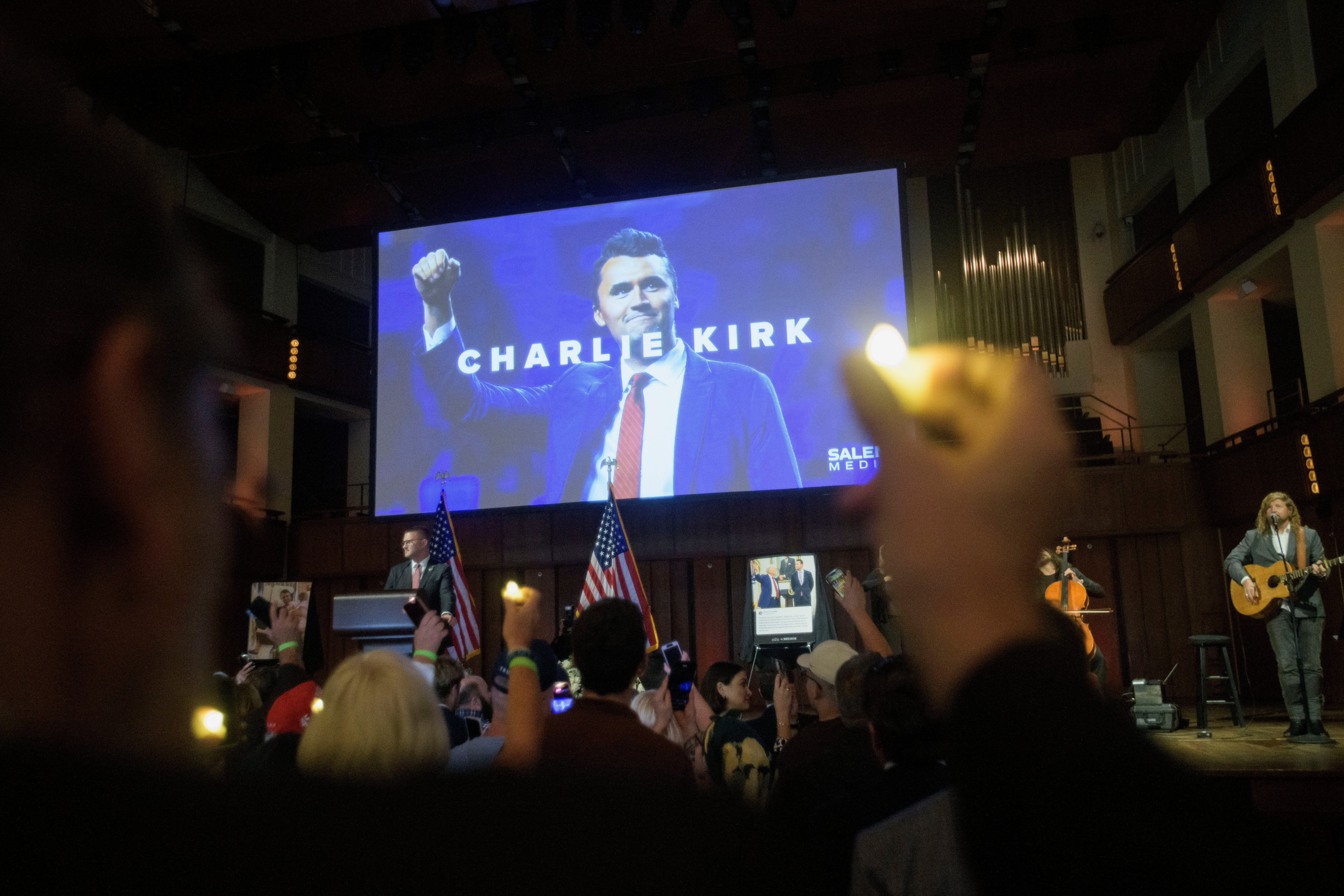People hold candles and sing during a memorial and prayer vigil for Charlie Kirk at the John F. Kennedy Memorial Center for the Performing Arts, Sunday, Sept. 14, 2025, in Washington. (Rod Lamkey - FR172078)