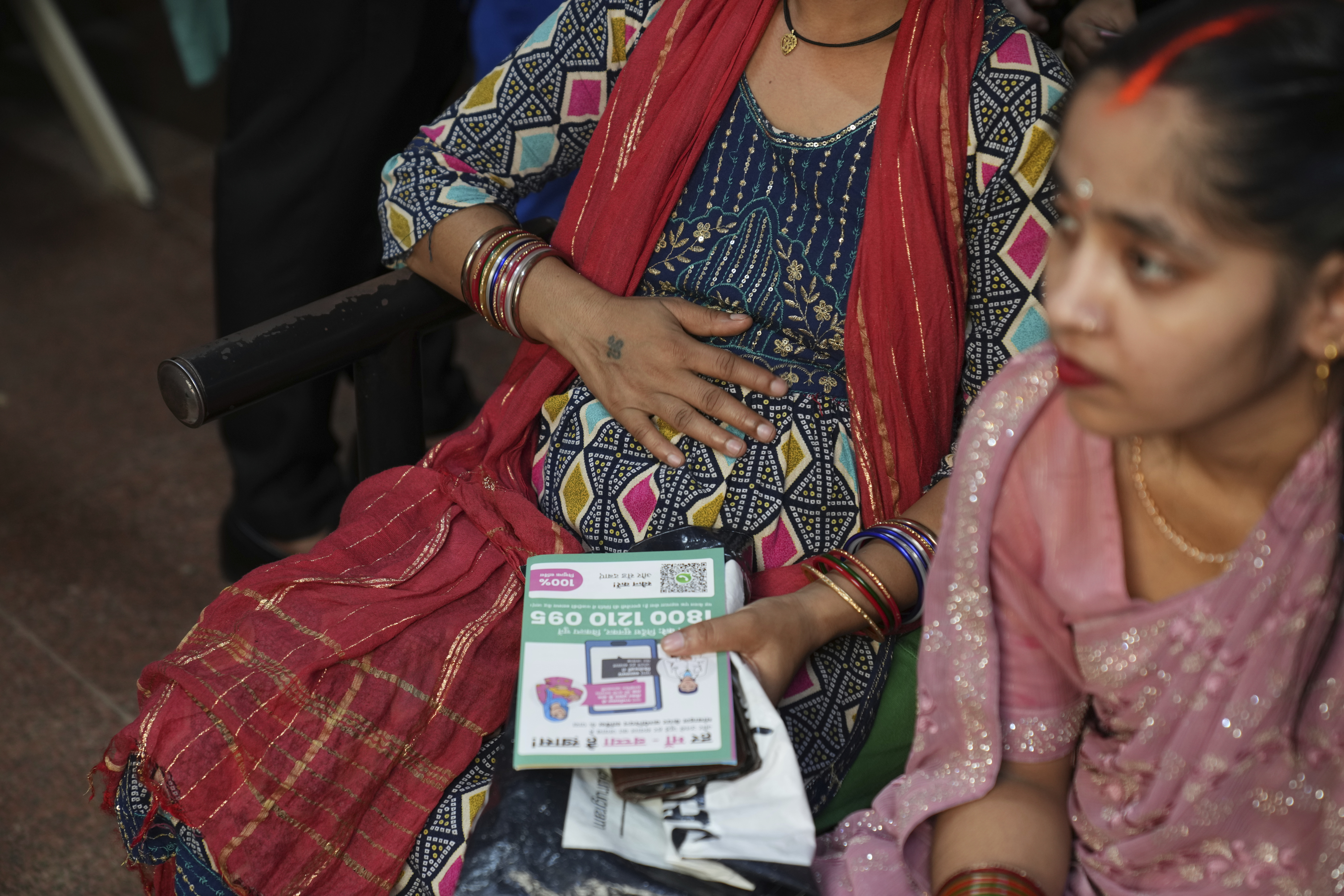 A pregnant woman puts her hand on her stomach as she participates in an antenatal Care Companion Program (CCP) at a government hospital in Gurugram, a satellite city of New Delhi, India, on Aug. 7, 2025. (Manish Swarup - AP)