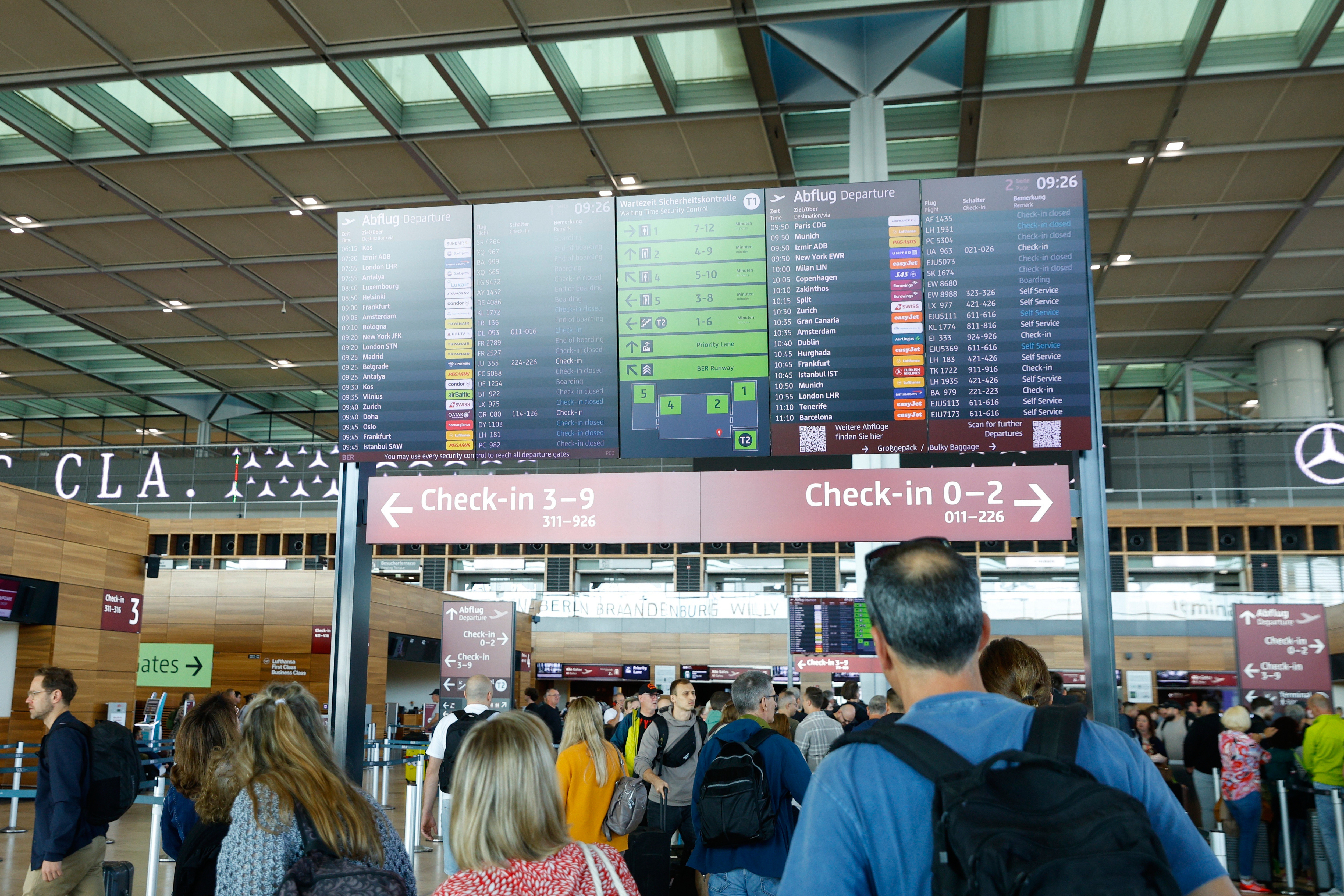 People at BER airport as a cyber attack has caused delays, in Berlin, Germany, Saturday, Sept. 20, 2025. (Carsten Koall - DPA)