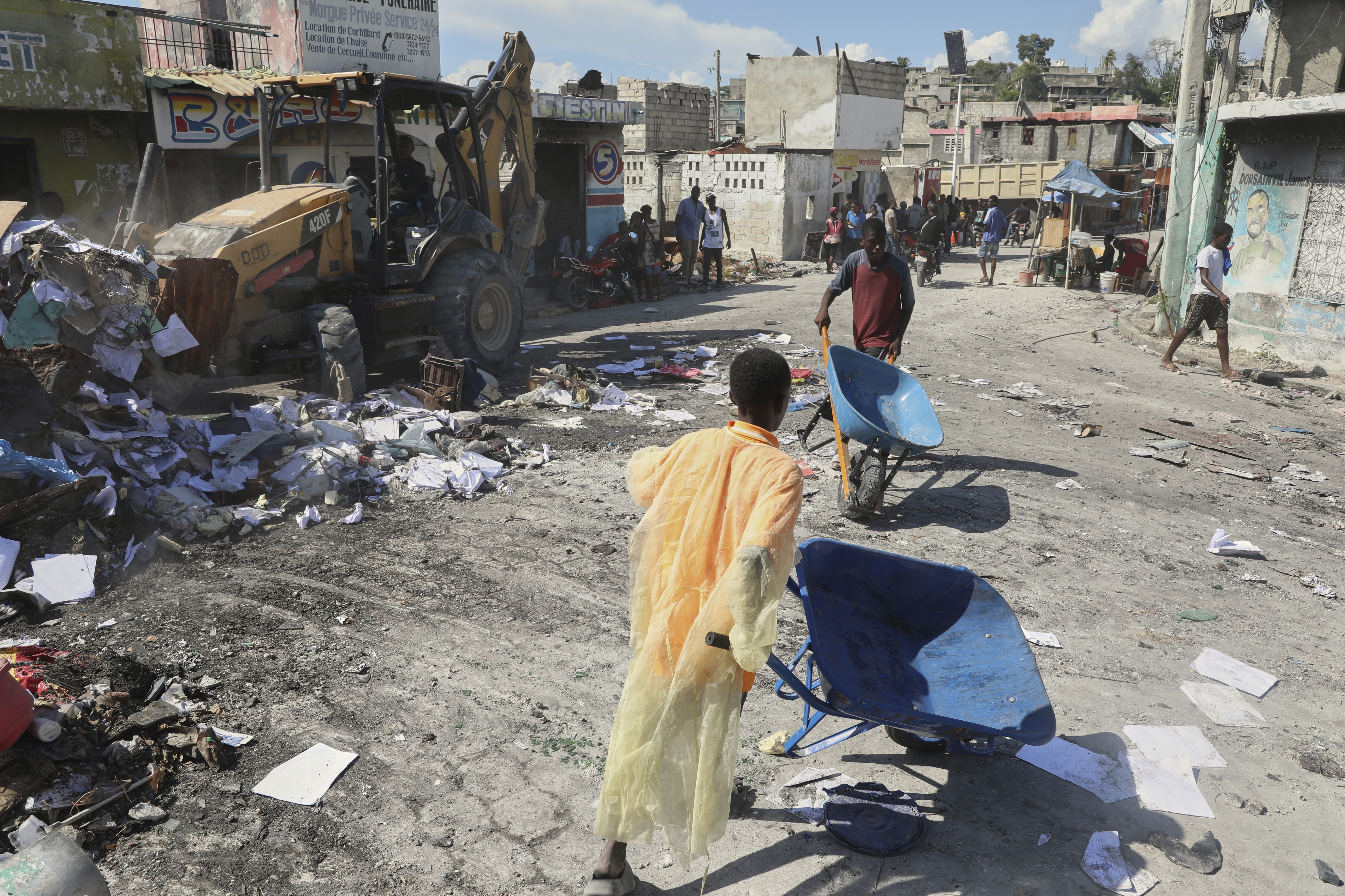 Youths use wheelbarrows to carry debris out of their homes, which were damaged by gang violence, in the Solino neighborhood of Port-au-Prince, Haiti, Wednesday, Sept. 10, 2025. (Odelyn Joseph - AP)