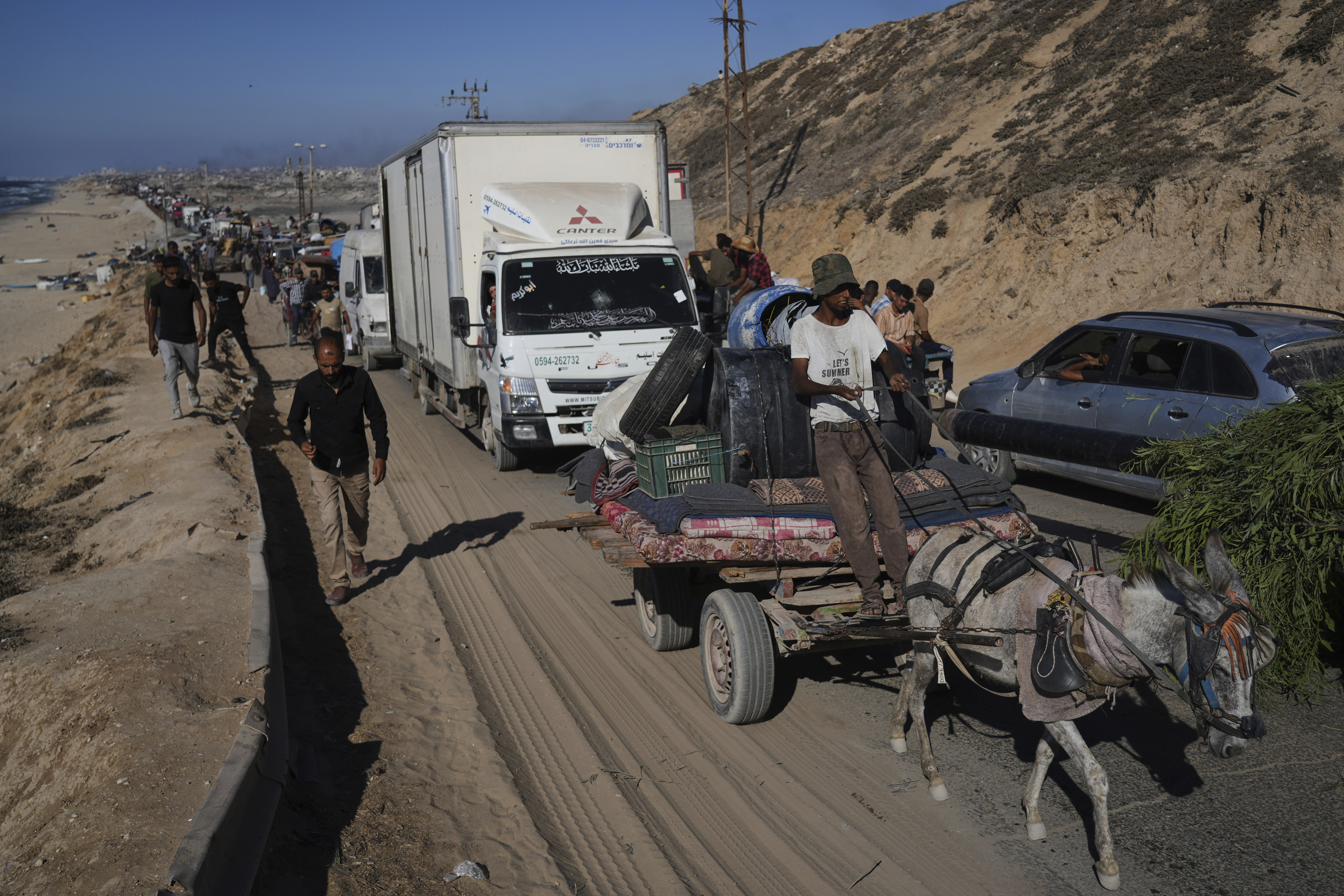 Displaced Palestinians fleeing northern Gaza carry their belongings along the coastal road toward southern Gaza, Wednesday, Sept. 10, 2025, after the Israeli army issued evacuation orders from Gaza City. (Abdel Kareem Hana - AP)
