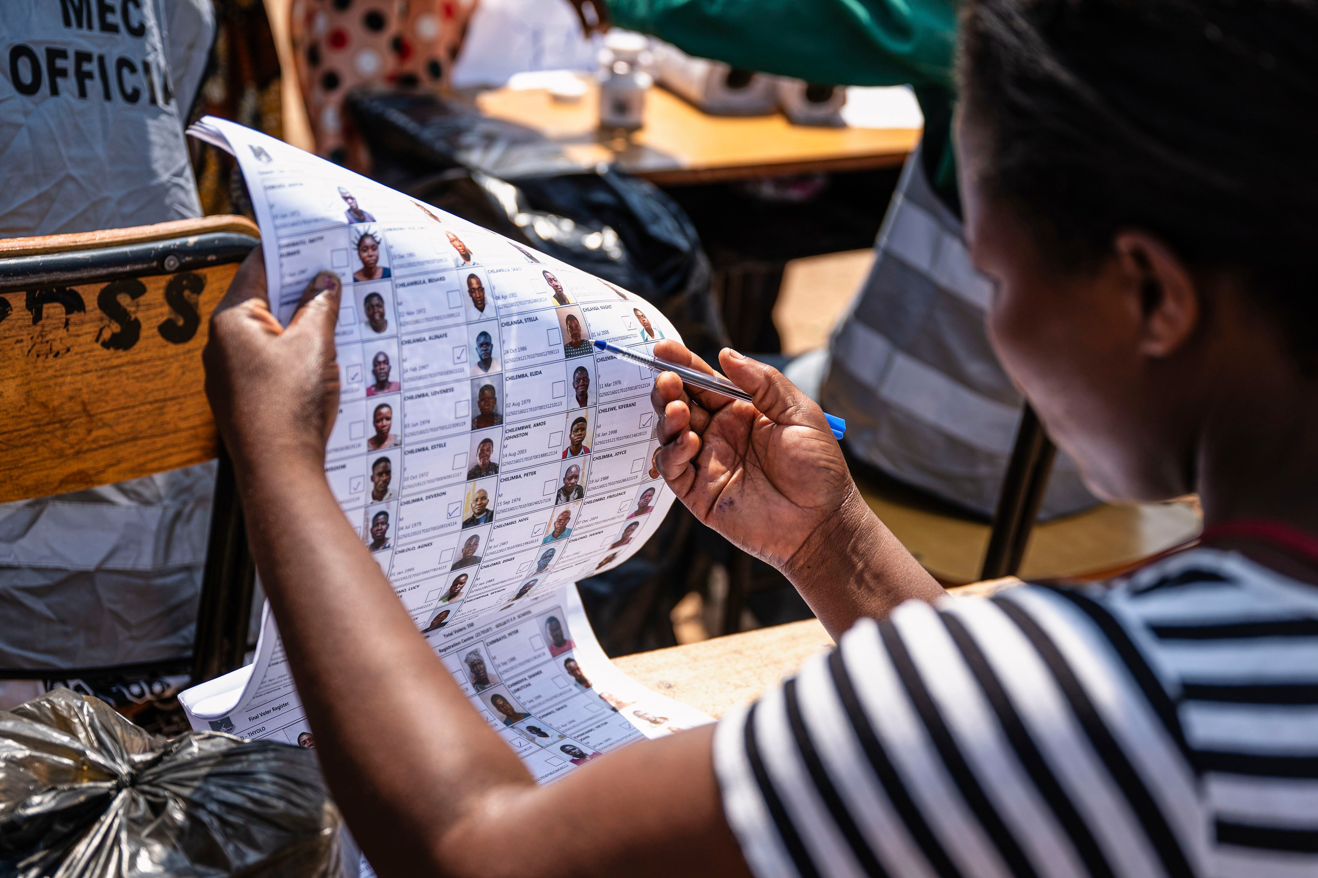 An election worker checks names in electoral rolls at a polling station in Thyolo District, Malawi, Tuesday, Sept. 16, 2025. (Thoko Chikondi - AP)