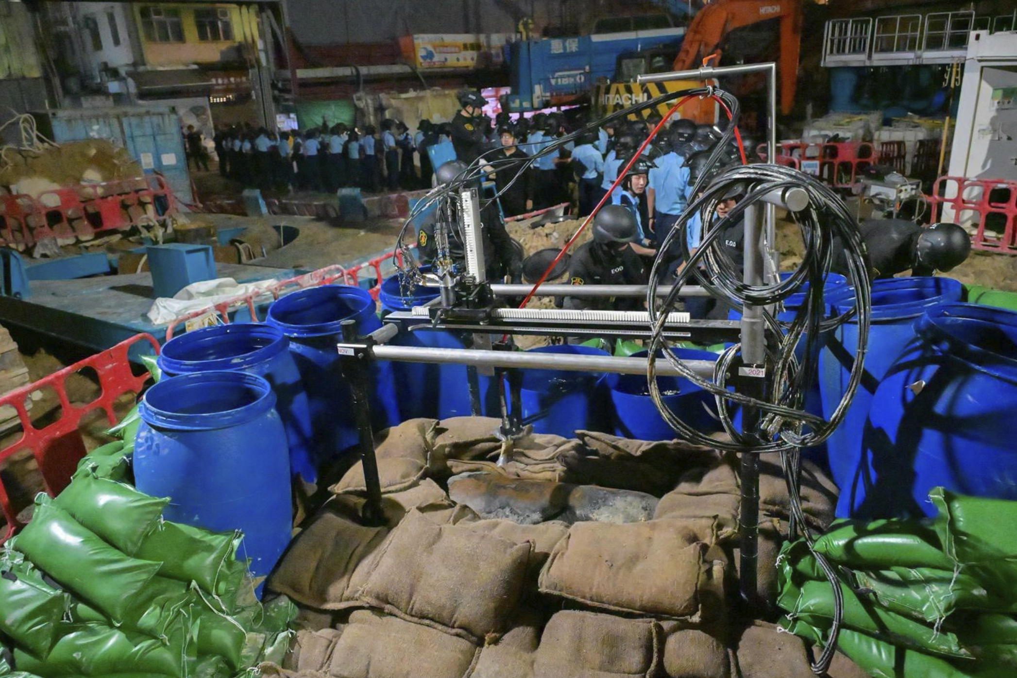In this photo taken in the early hours of Sept. 20. 2025 and released by Hong Kong Police, police officers prepare to defuse a large U.S.-made bomb left over from World War II that was discovered at a construction site in Hong Kong. (Uncredited - Hong Kong Police)
