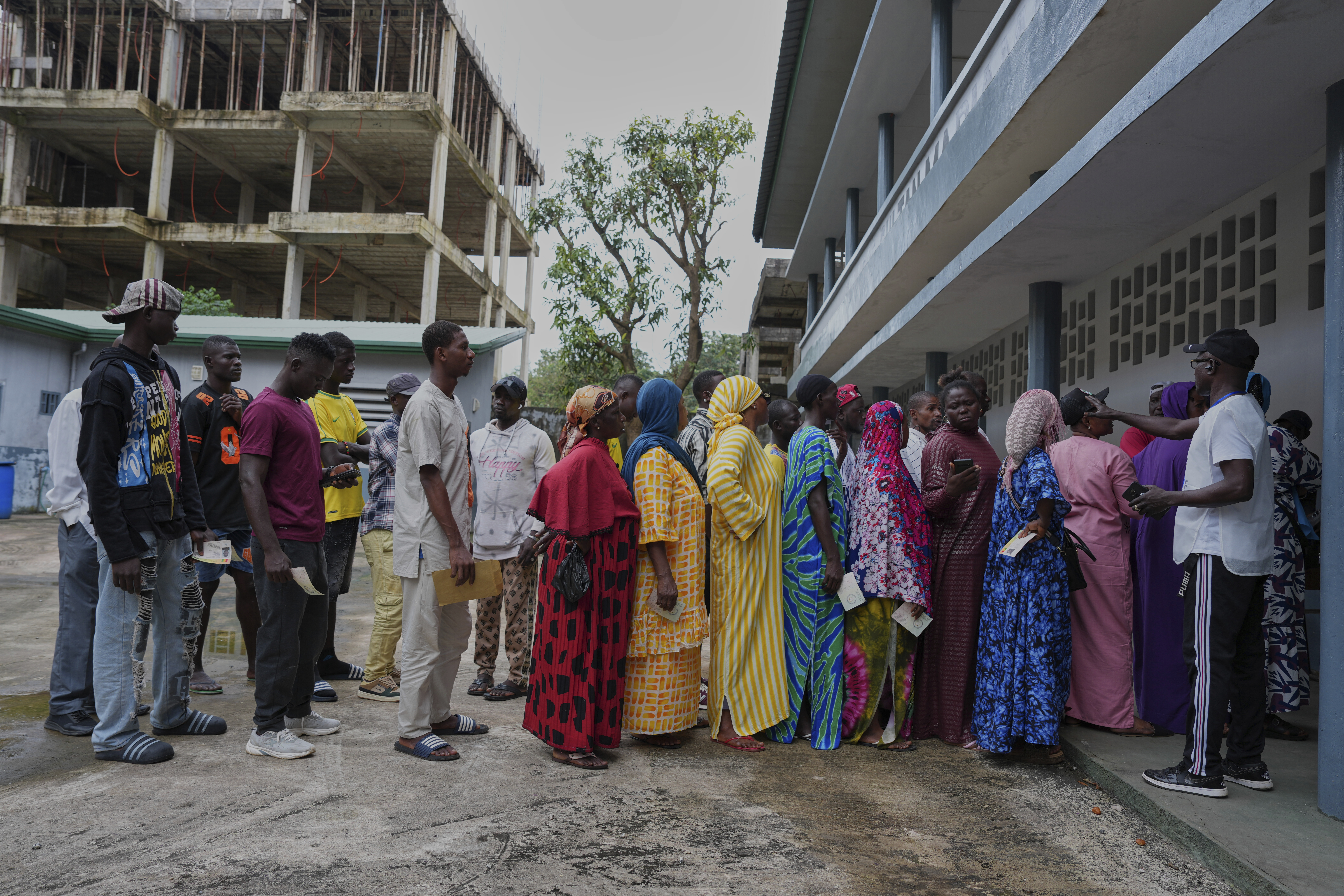 Voters queue to cast their votes in the constitutional referendum, in Conakry, Guinea, Sunday, Sept. 21, 2025. (Misper Apawu - AP)