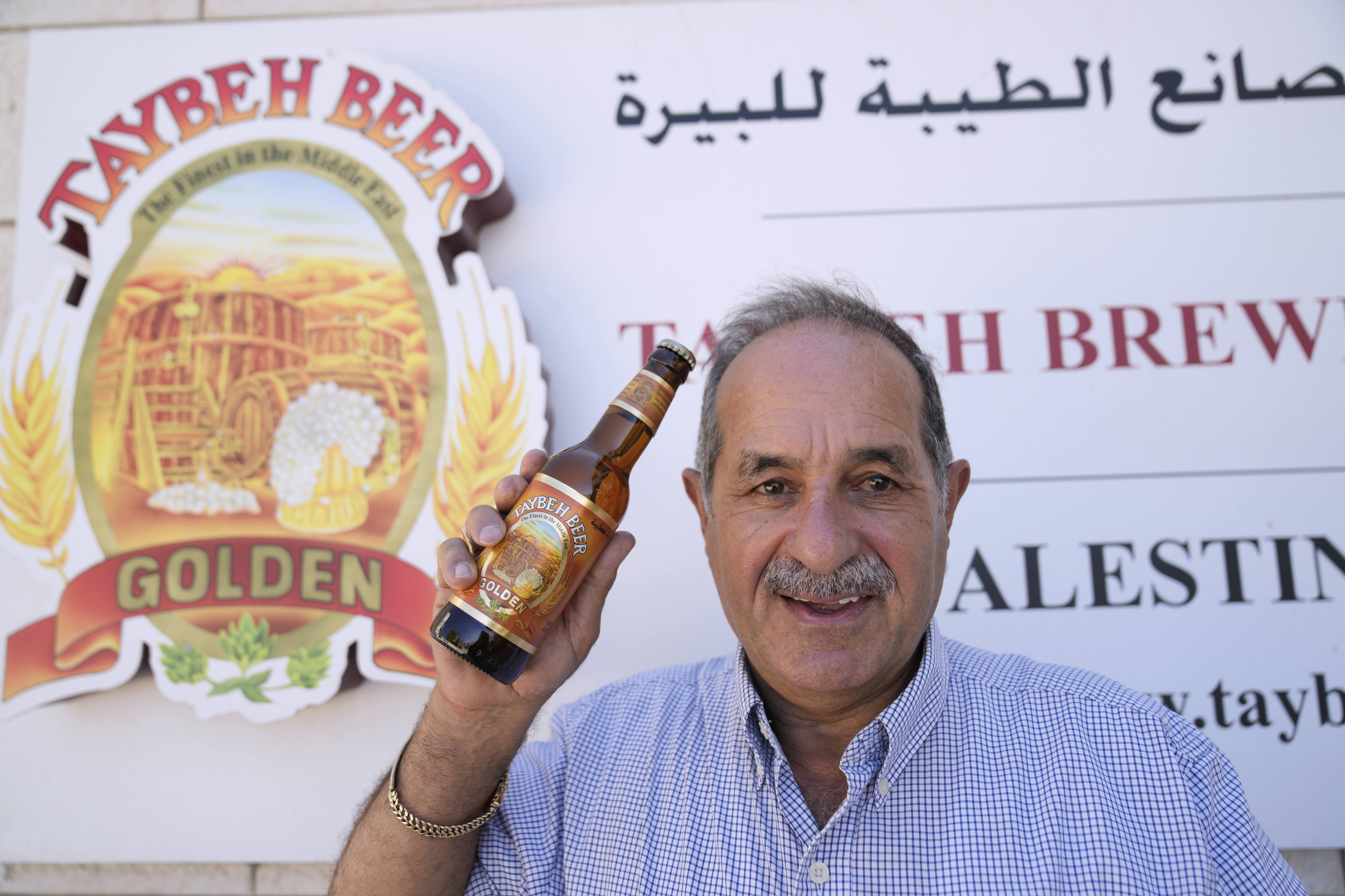 General Director Nadim Khoury shows a bottle of Taybeh beer at the family's Palestinian Taybeh Brewery Co. in the West Bank town of Taybeh, Saturday, Sept. 6, 2025. (Nasser Nasser - AP)