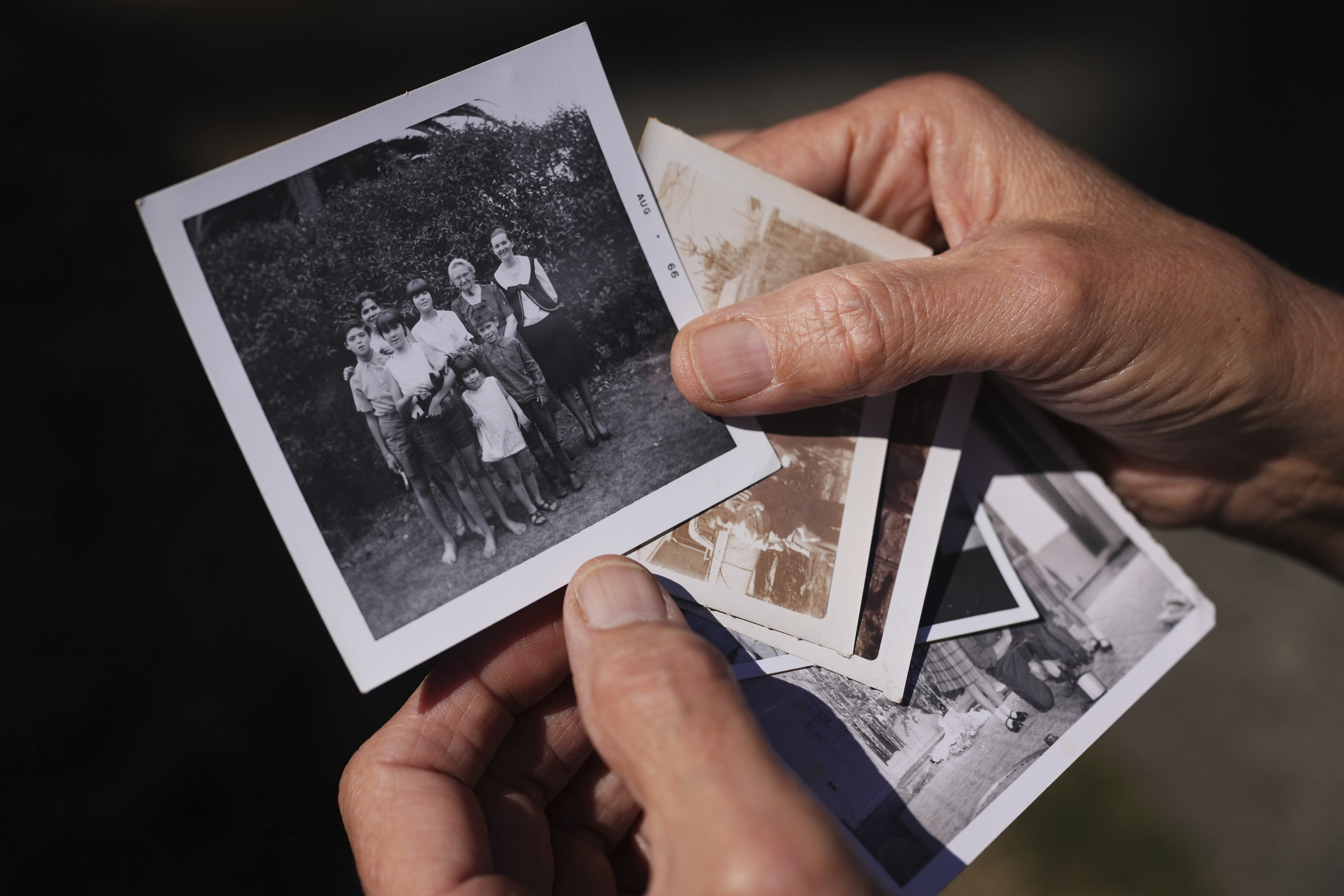 A family photo of Marion Vinetta Nagle McWhorter, back center in white, who disappeared in 1974 in Oregon, and whose remains were recently identified, is held by her sister Valerie Nagle Thursday, Sept. 18, 2025, in Seattle. (Lindsey Wasson - AP)