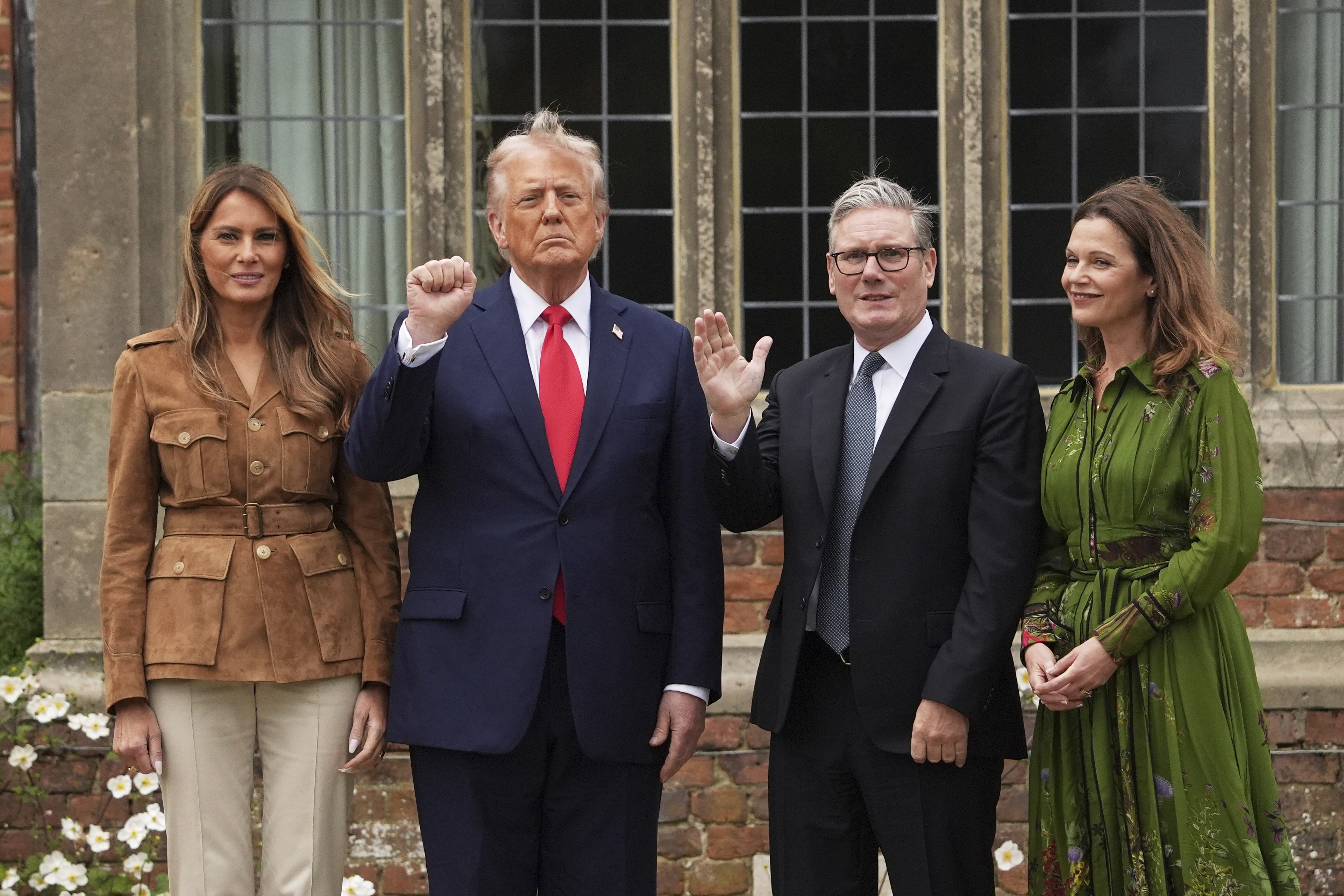President Donald Trump and Britain's Prime Minister Keir Starmer gesture next to first lady Melania Trump and Victoria Starmer after watching a display by the British Parachute Regiment's