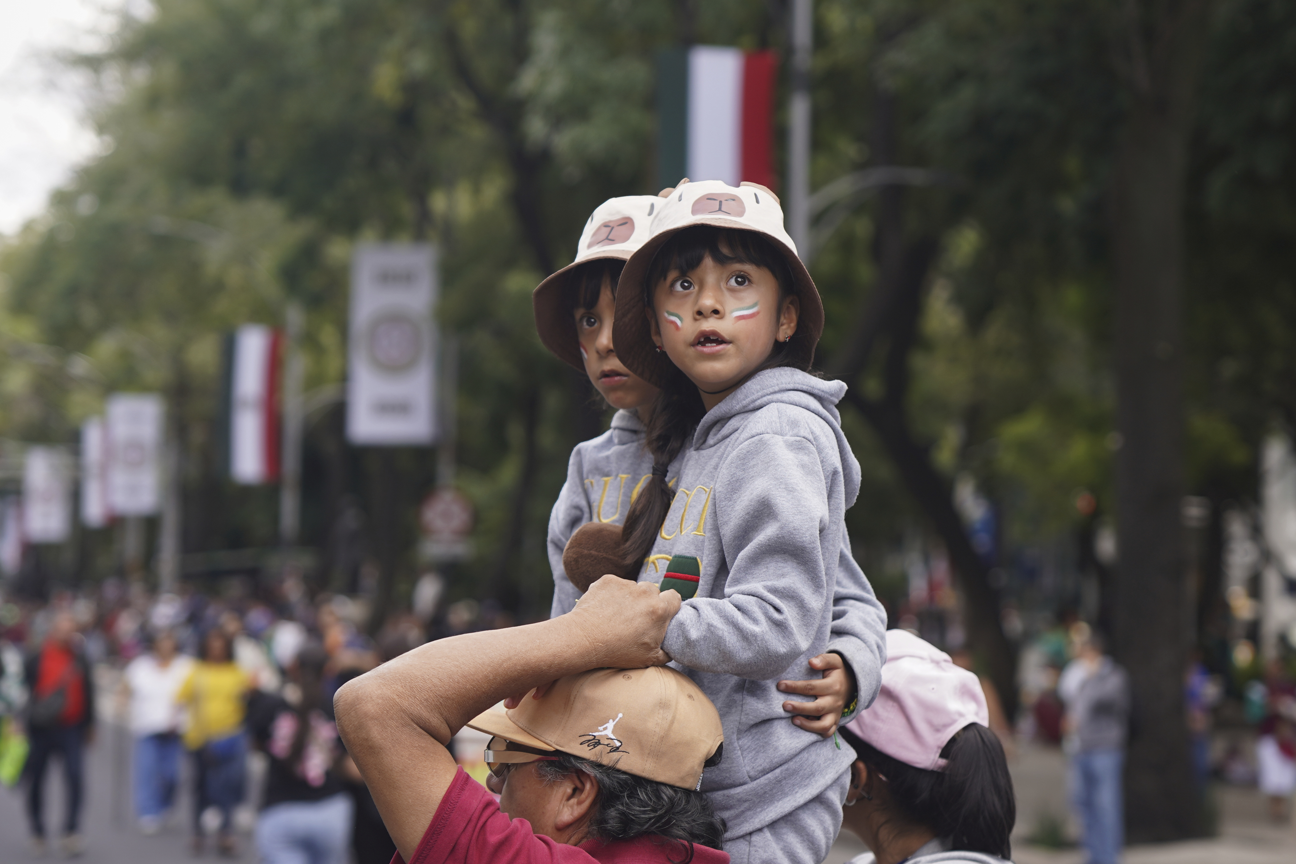 Children look out at the Independence Day military parade along Reforma Ave. in Mexico City, Tuesday, Sept. 16, 2025. (Jon Orbach - AP)