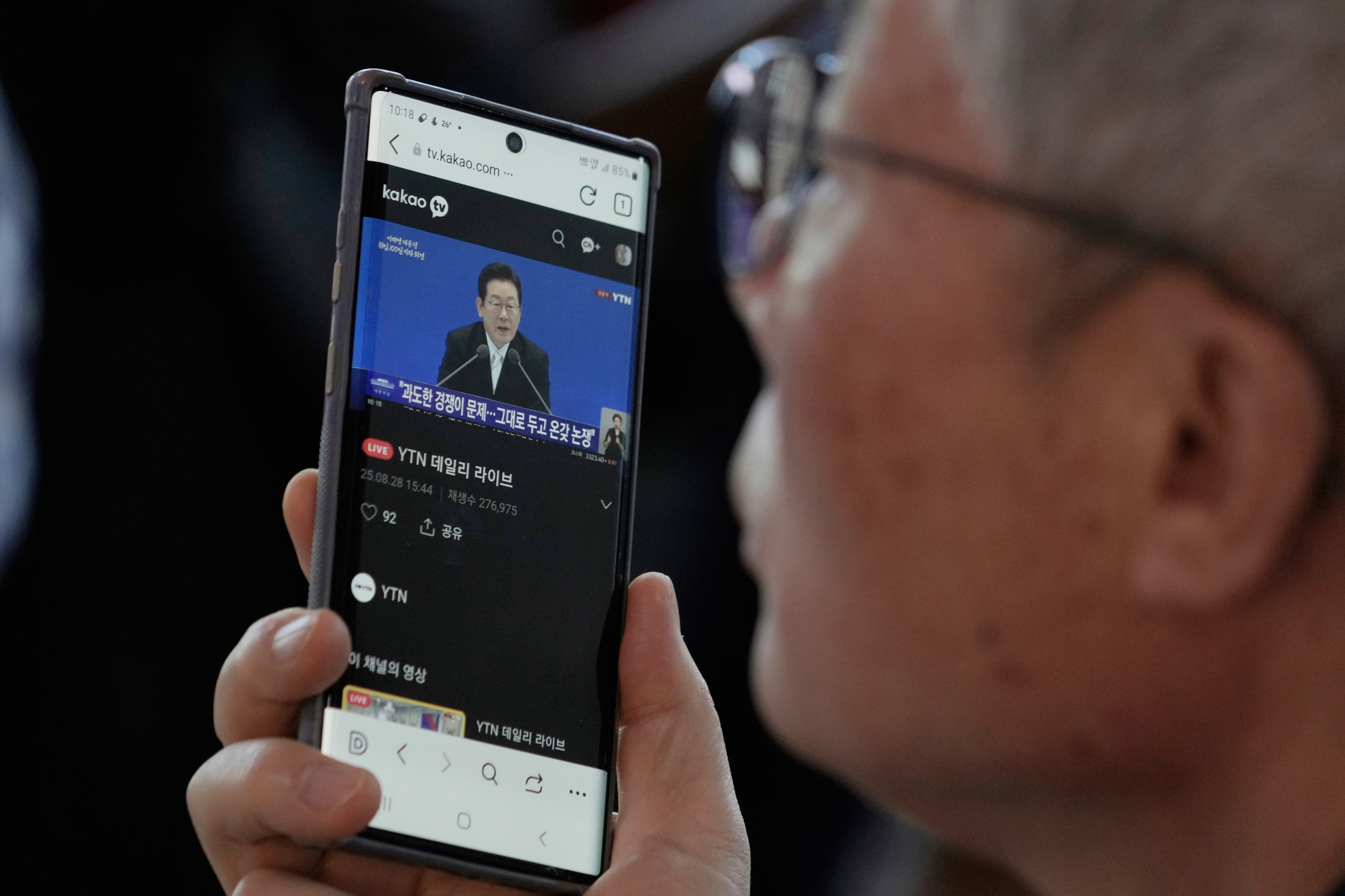 A smart phone screen shows the live broadcast of South Korean President Lee Jae Myung's press conference at the Seoul Railway Station in Seoul, South Korea, Thursday, Sept. 11, 2025. (Ahn Young-joon - AP)