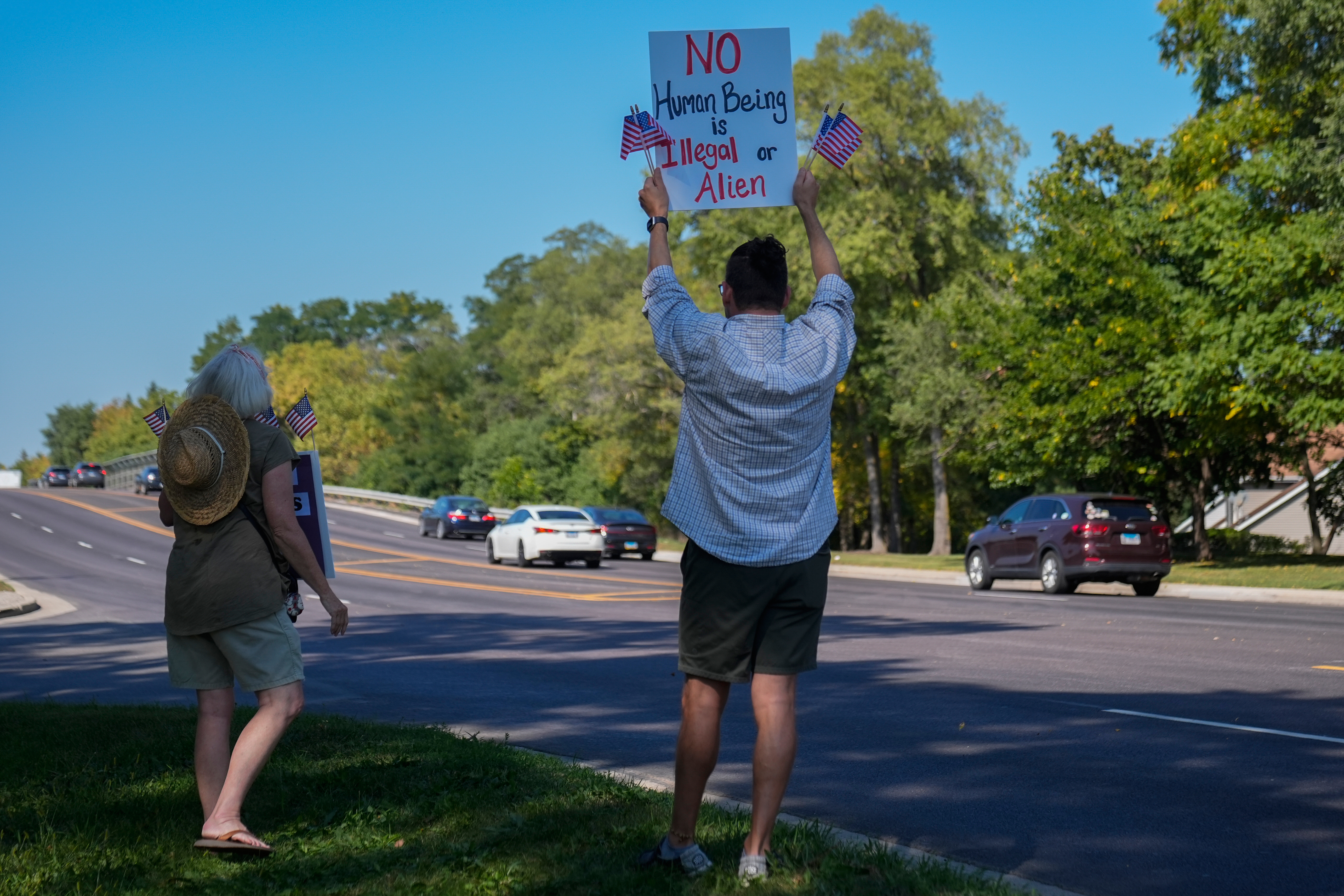 People hold pro-immigrant signs near the Jel Sert Company building, Monday, Sept. 15, 2025, in West Chicago, Ill. (Erin Hooley - AP)