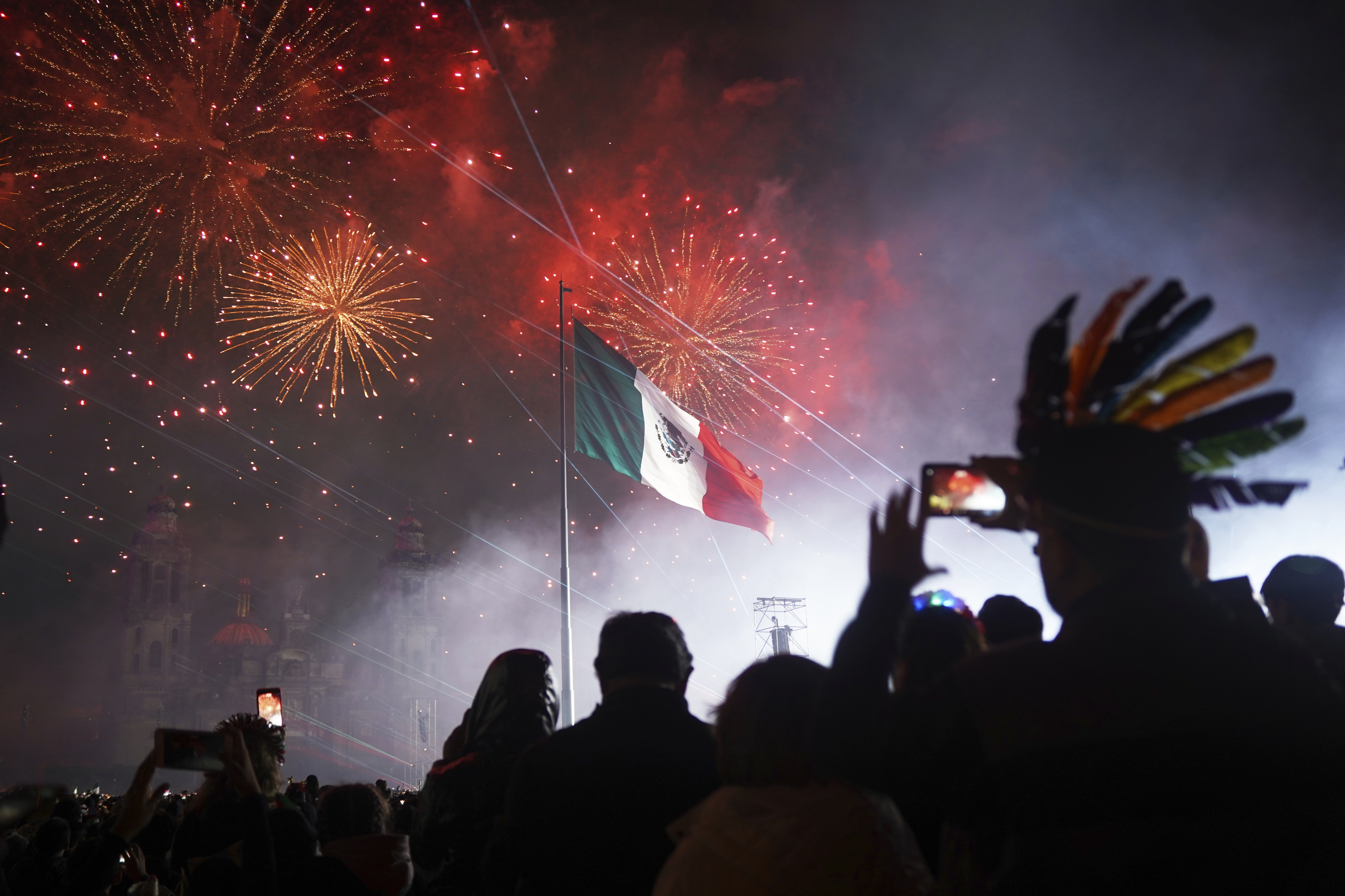 People watch fireworks during the Independence Day celebration at the Zocalo, Mexico City's main square, Monday, Sept. 15, 2025. (Jon Orbach - AP)