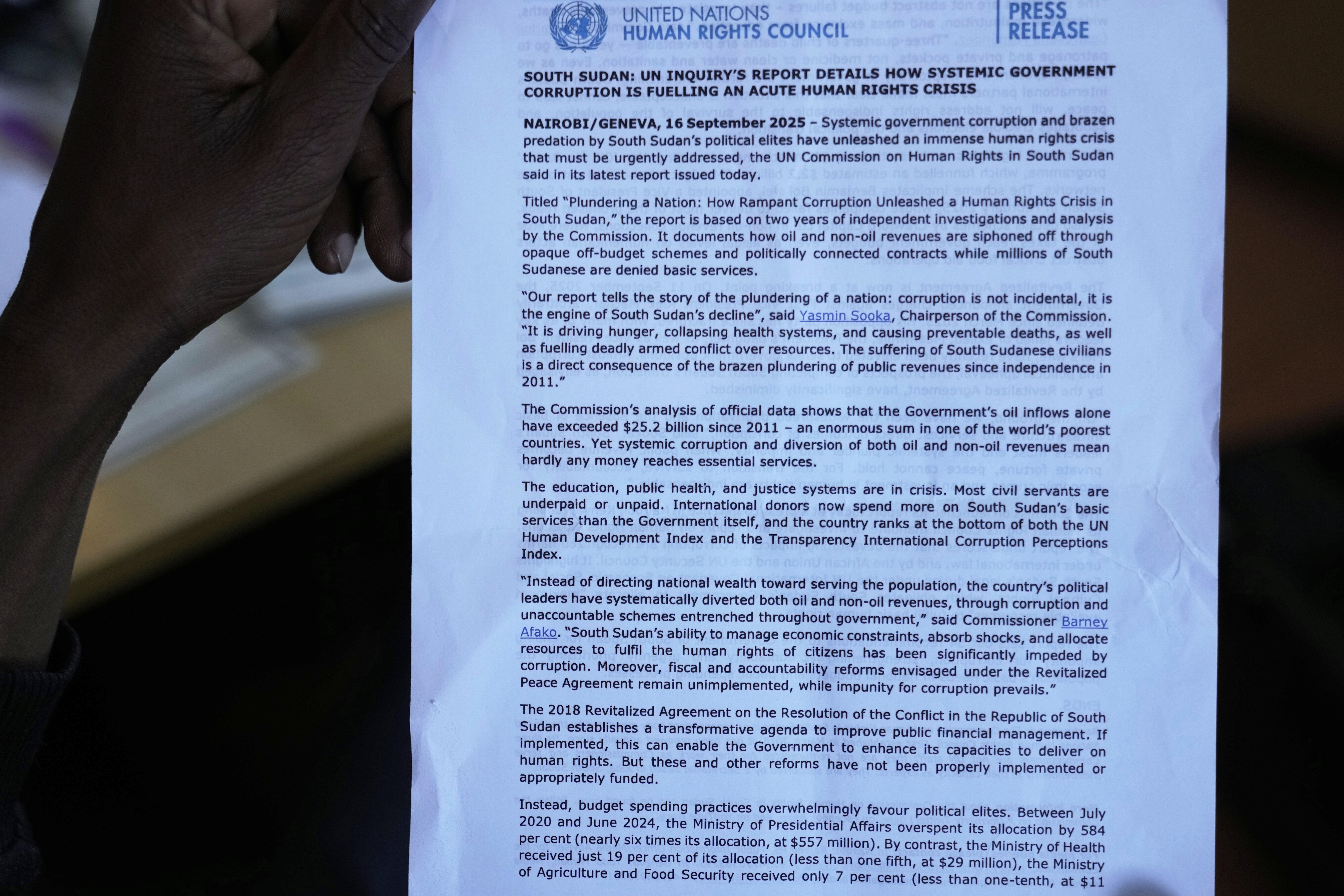 A journalist holds a press release on the United Nations inquiry's report into South Sudan, detailing how systematic government corruption is fueling an acute human rights crisis, during a press conference in Nairobi, Kenya, Tuesday, Sept. 16, 2025. (Brian Inganga - AP)