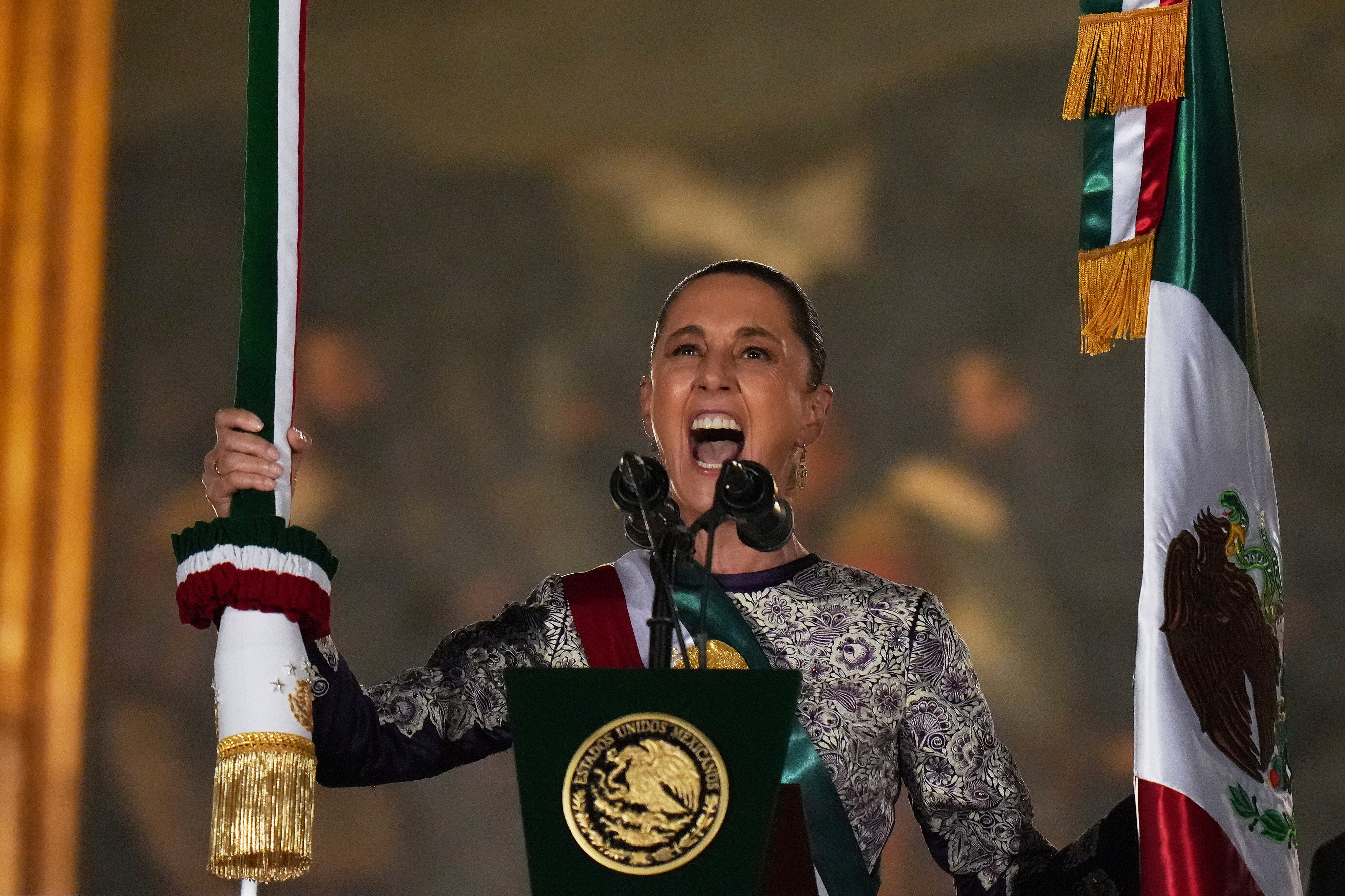 President Claudia Sheinbaum rings the bell as she gives the annual independence shout from the balcony of the National Palace to kick off Independence Day celebrations at the Zocalo, Mexico City's main square, Monday, Sept. 15, 2025. (Eduardo Verdugo - AP)