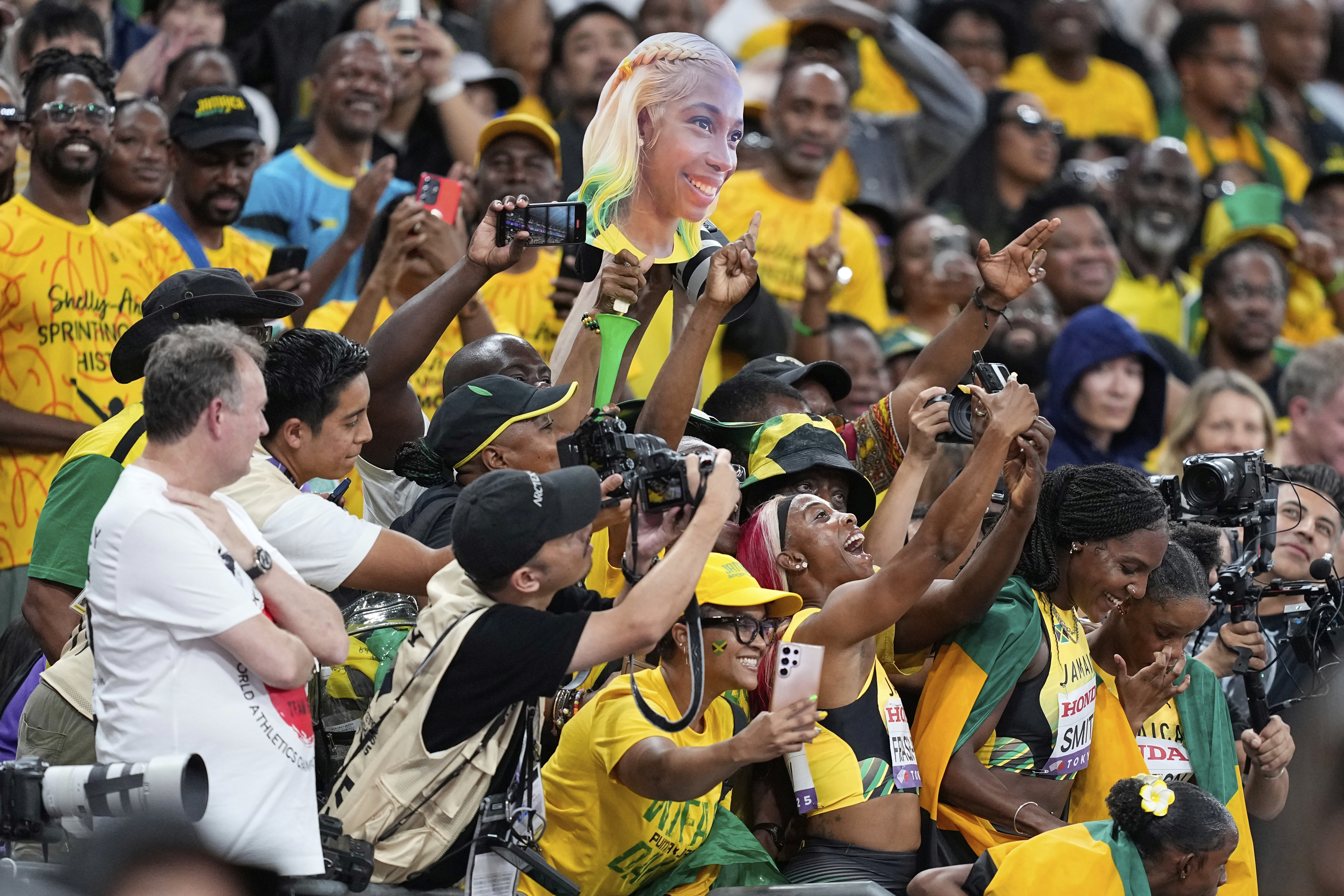 Jamaica's Shelly-Ann Fraser-Pryce and her teammates celebrate with supporters after taking the silver in the women's 4 X 100 meters relay final at the World Athletics Championships in Tokyo, Sunday, Sept. 21, 2025. (Petr David Josek - AP)