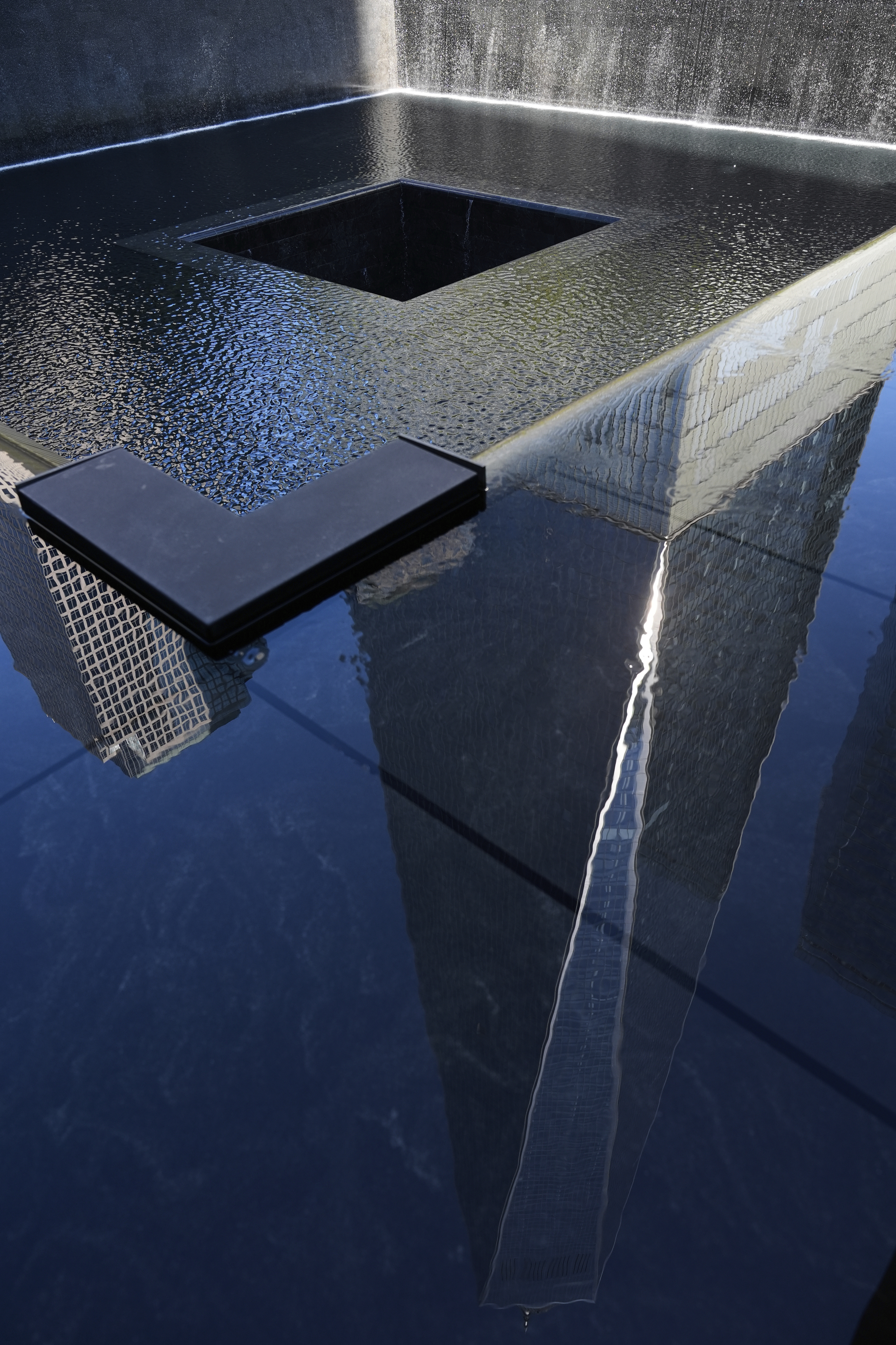 One World Trade is seen reflected in a pool during a ceremony to mark the 24th anniversary of the 9/11 attacks, Thursday, Sept. 11, 2025, in New York. (Seth Wenig - AP)
