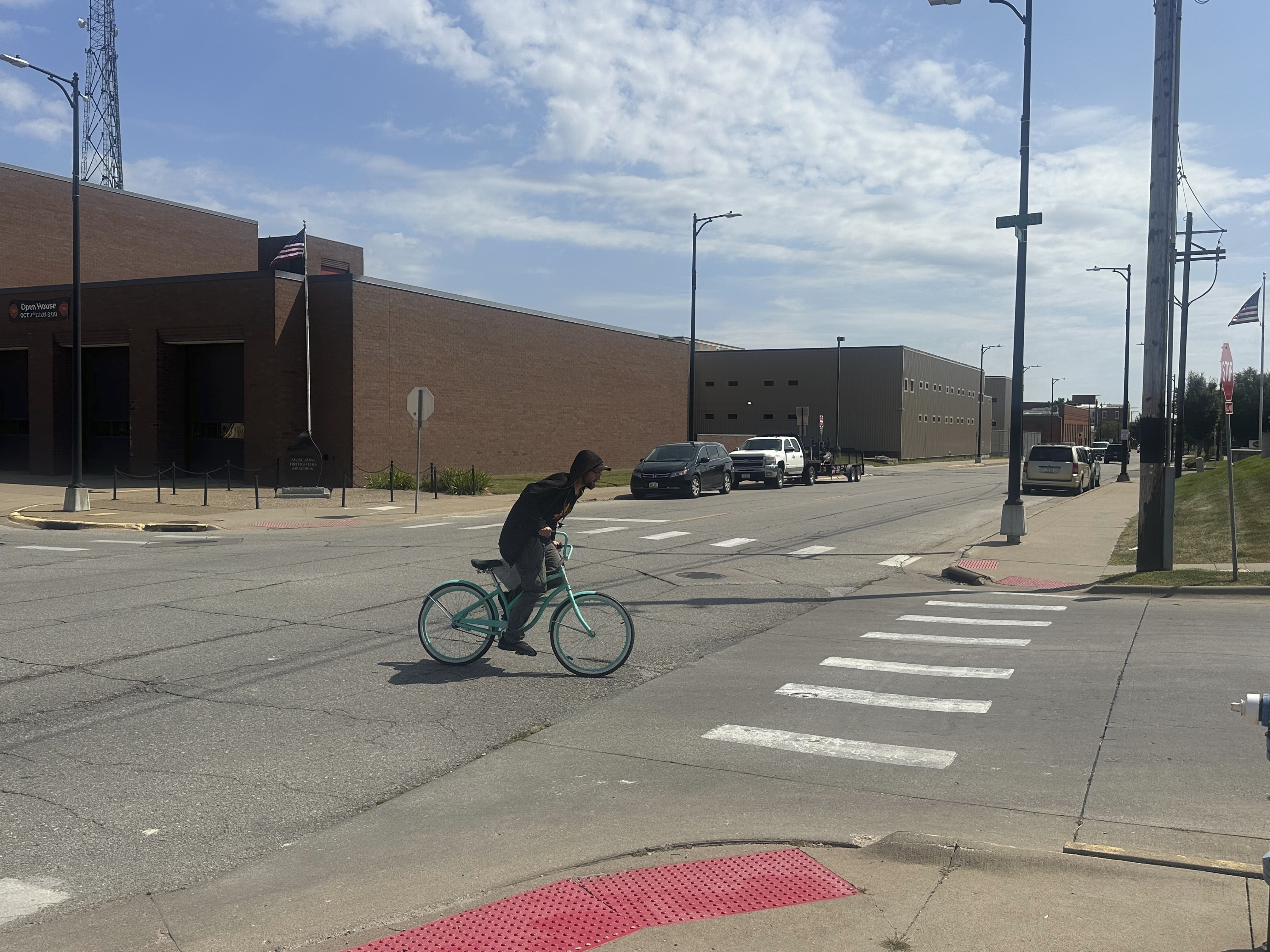 A cyclist crosses an intersection, on Monday, Sept. 8, 2025, where witnesses found Felipe de Jesus Hernandez Marcelo covered in blood after he was shot on June 21, in Muscatine, Iowa. (Ryan J. Foley - AP)