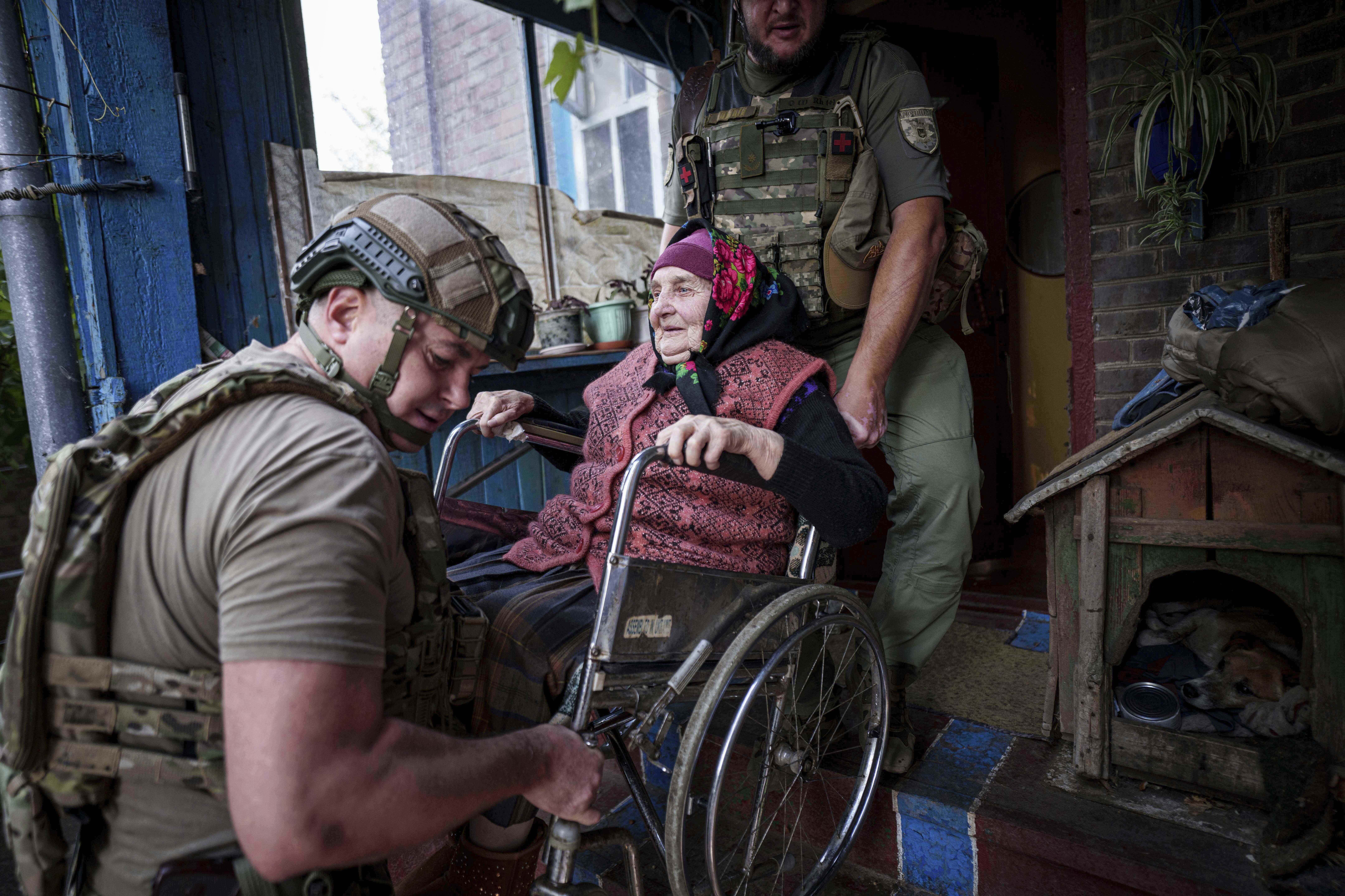 Police officers evacuate Maria Hodus, 90, from her house in Kostiantynivka, Ukraine, Tuesday, Sept. 2, 2025. (Evgeniy Maloletka - AP)