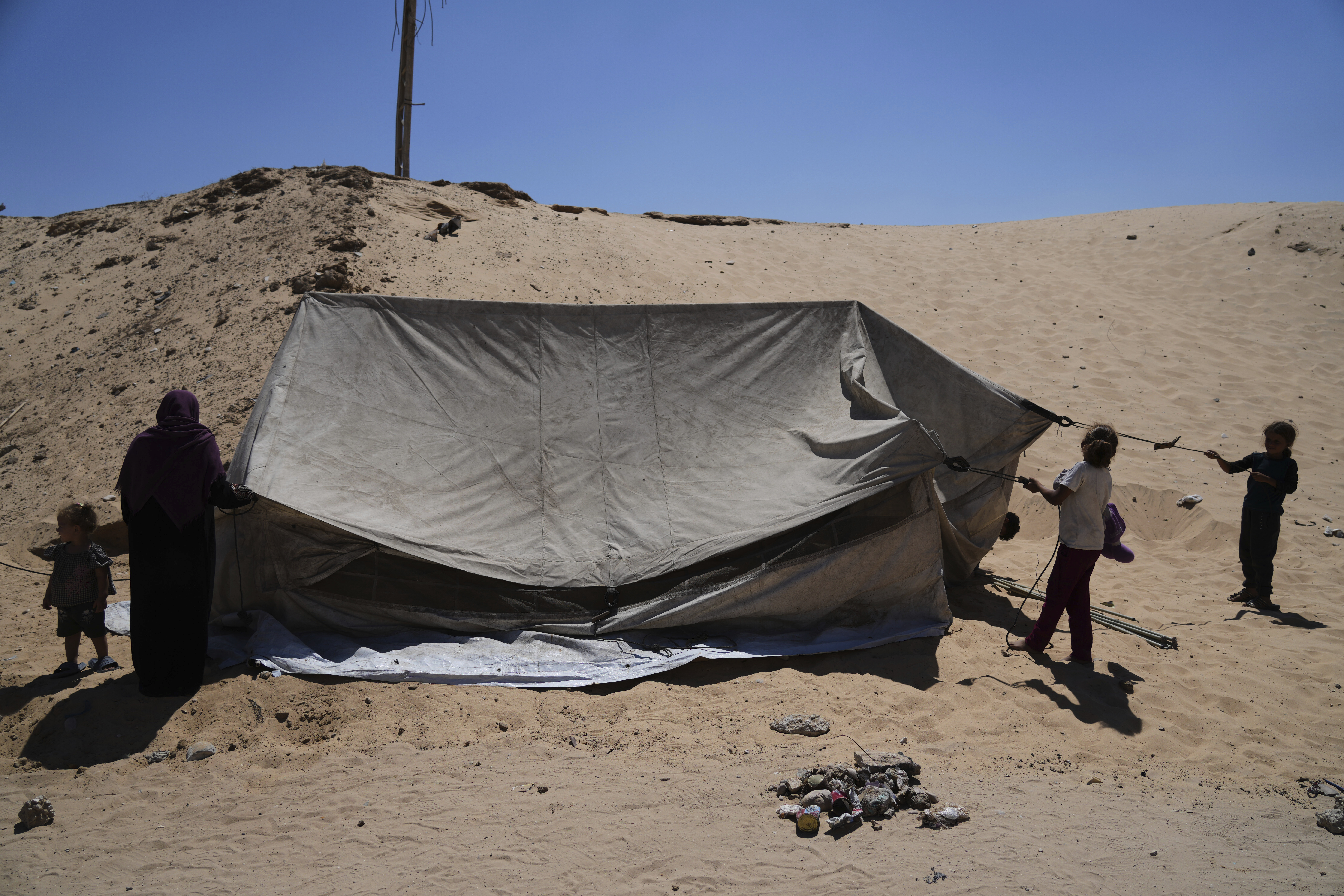 Members of the Abdullah family who were evacuated from Gaza City set up their tent in a camp for displaced Palestinians in Muwasi, an area that Israel has designated as a safe zone, in Khan Younis southern Gaza Strip, Wednesday, Sept. 10, 2025. (Jehad Alshrafi - AP)