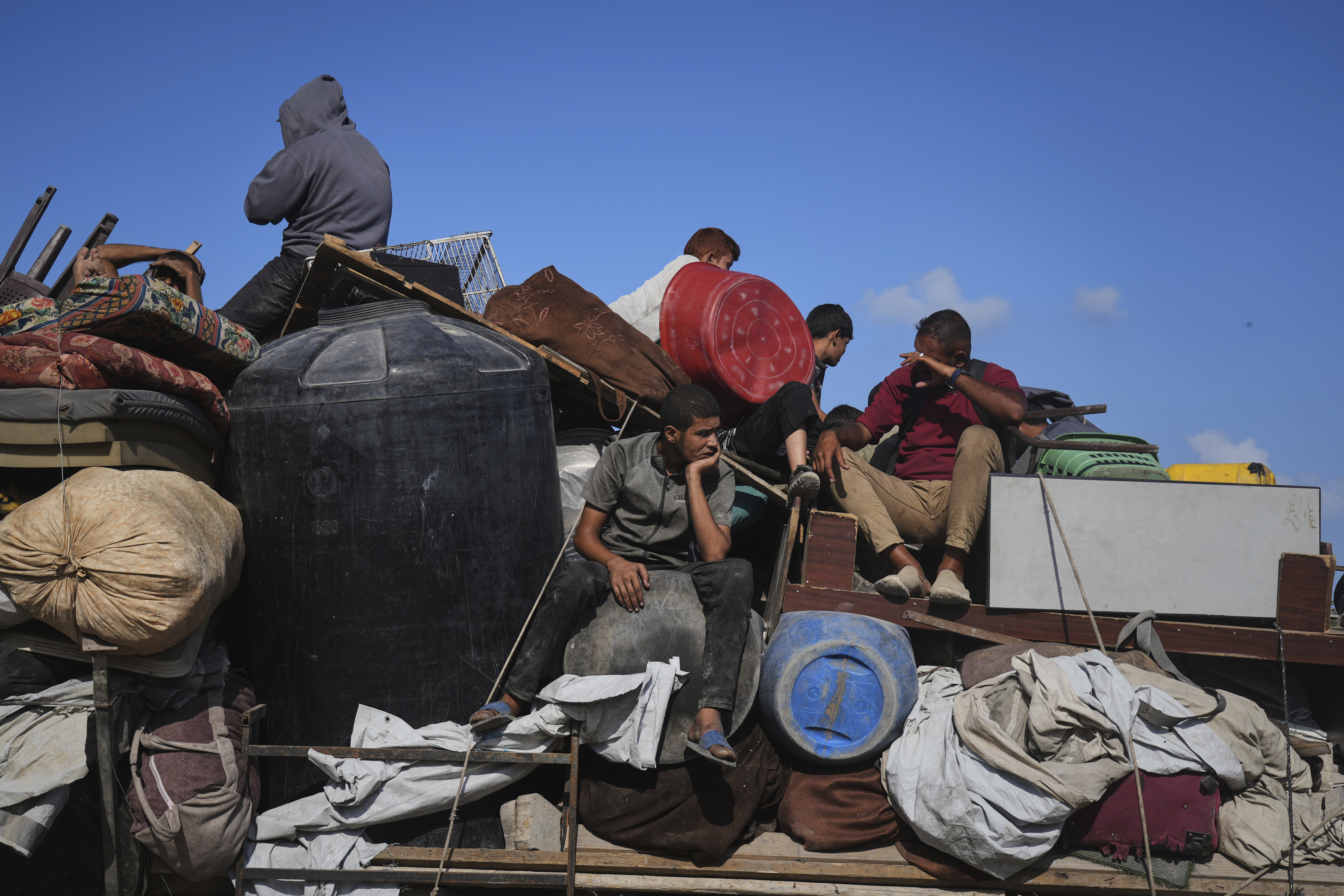 Displaced Palestinians carry their belongings as they flee northern Gaza along the coastal road toward the south, as Israel announced an expanded operation in Gaza City, Tuesday, Sept. 16, 2025. (Abdel Kareem Hana - AP)