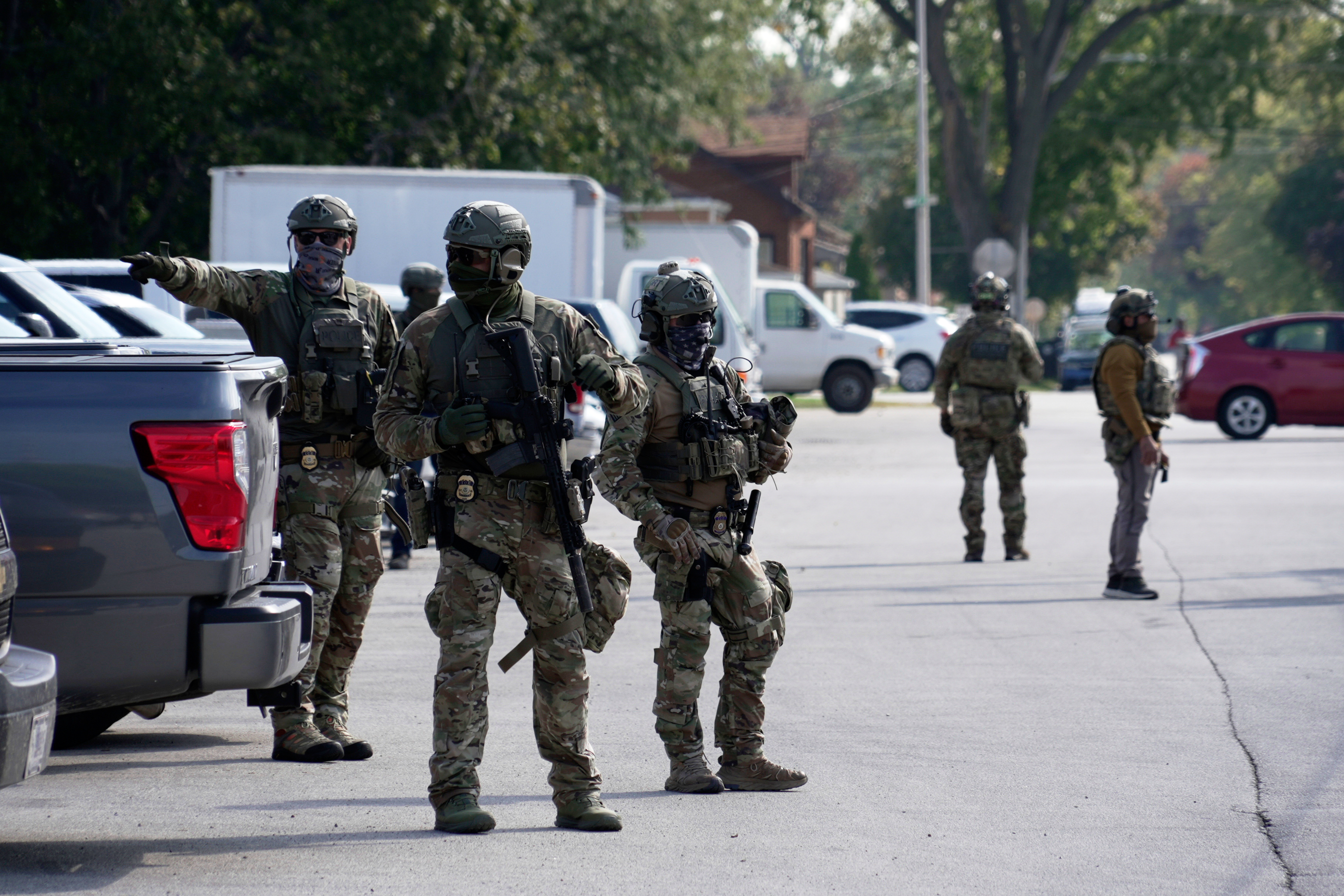 Federal agents stand guard as a planned protest starts outside of an immigration facility in Broadview, Ill. Friday, Sept. 12, 2025. (Laura Bargfeld - AP)
