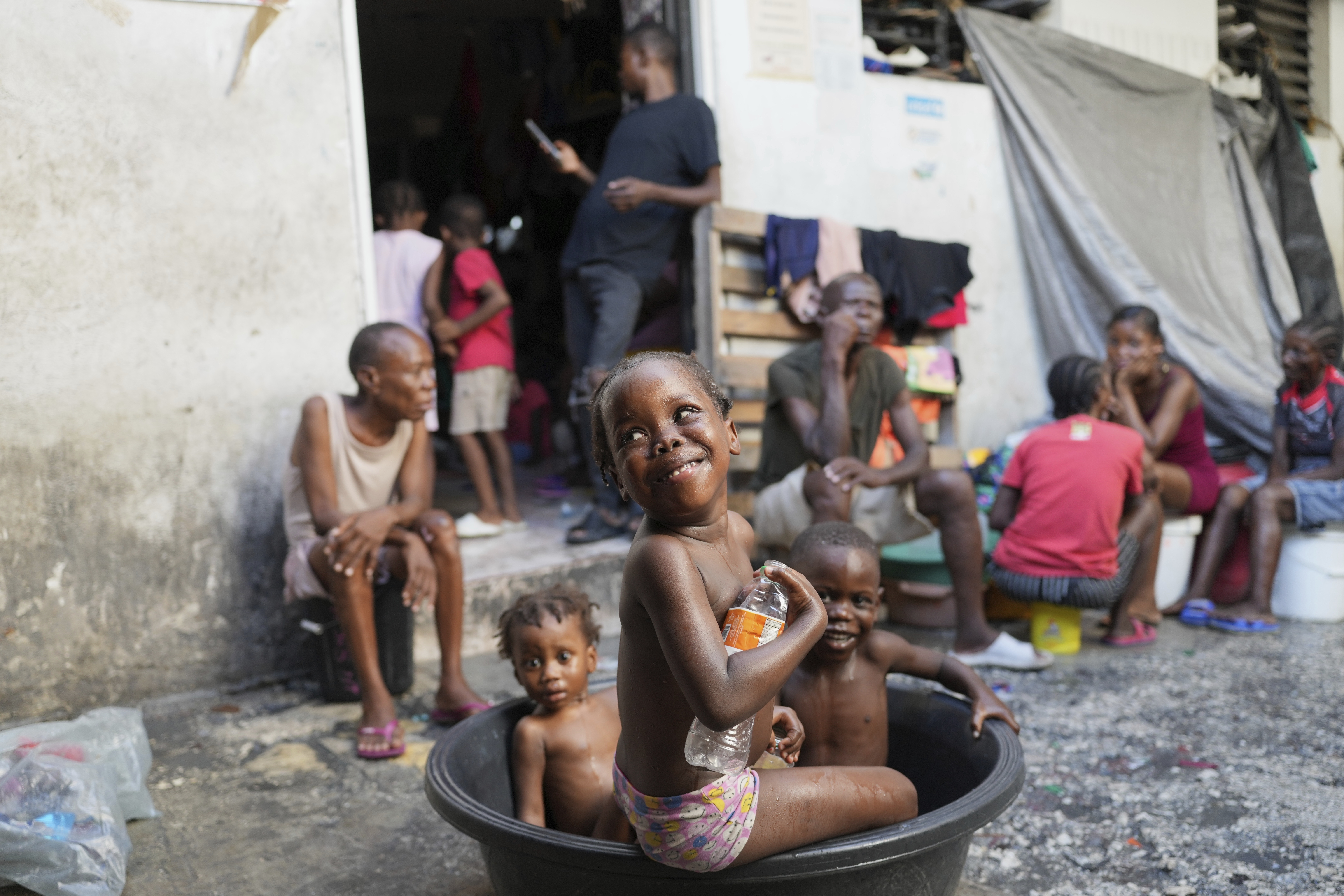 Children bathe at a makeshift shelter for people displaced by gang violence in Port-au-Prince, Haiti, Wednesday, Sept. 17, 2025. (Odelyn Joseph - AP)