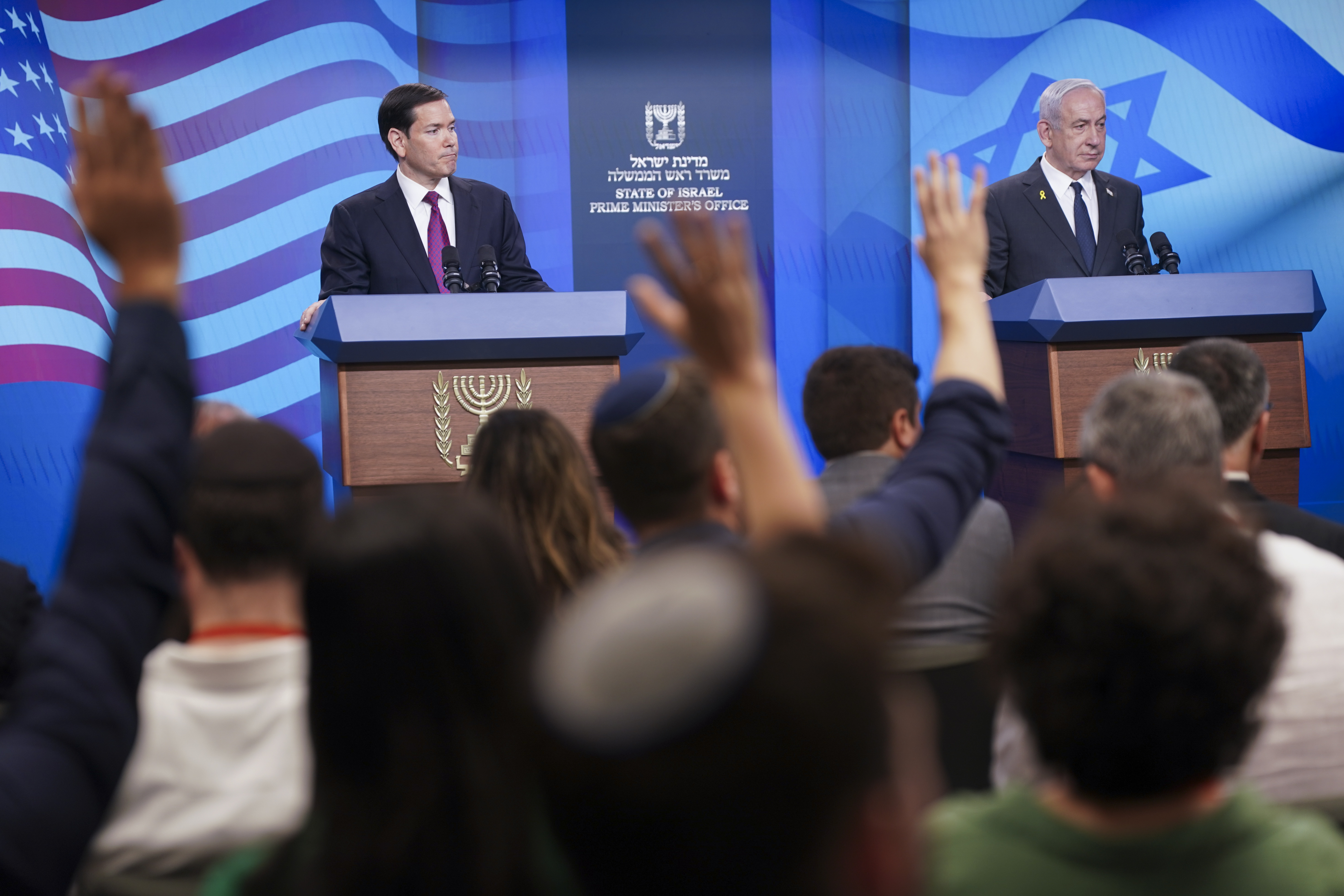 Journalists raise their hands as Israeli Prime Minister Benjamin Netanyahu, right, and U.S. Secretary of State Marco Rubio hold a joint press conference at the Prime Minister's Office, during Rubio's visit, in Jerusalem, Monday, Sept. 15, 2025. (Nathan Howard - Pool Reuters)