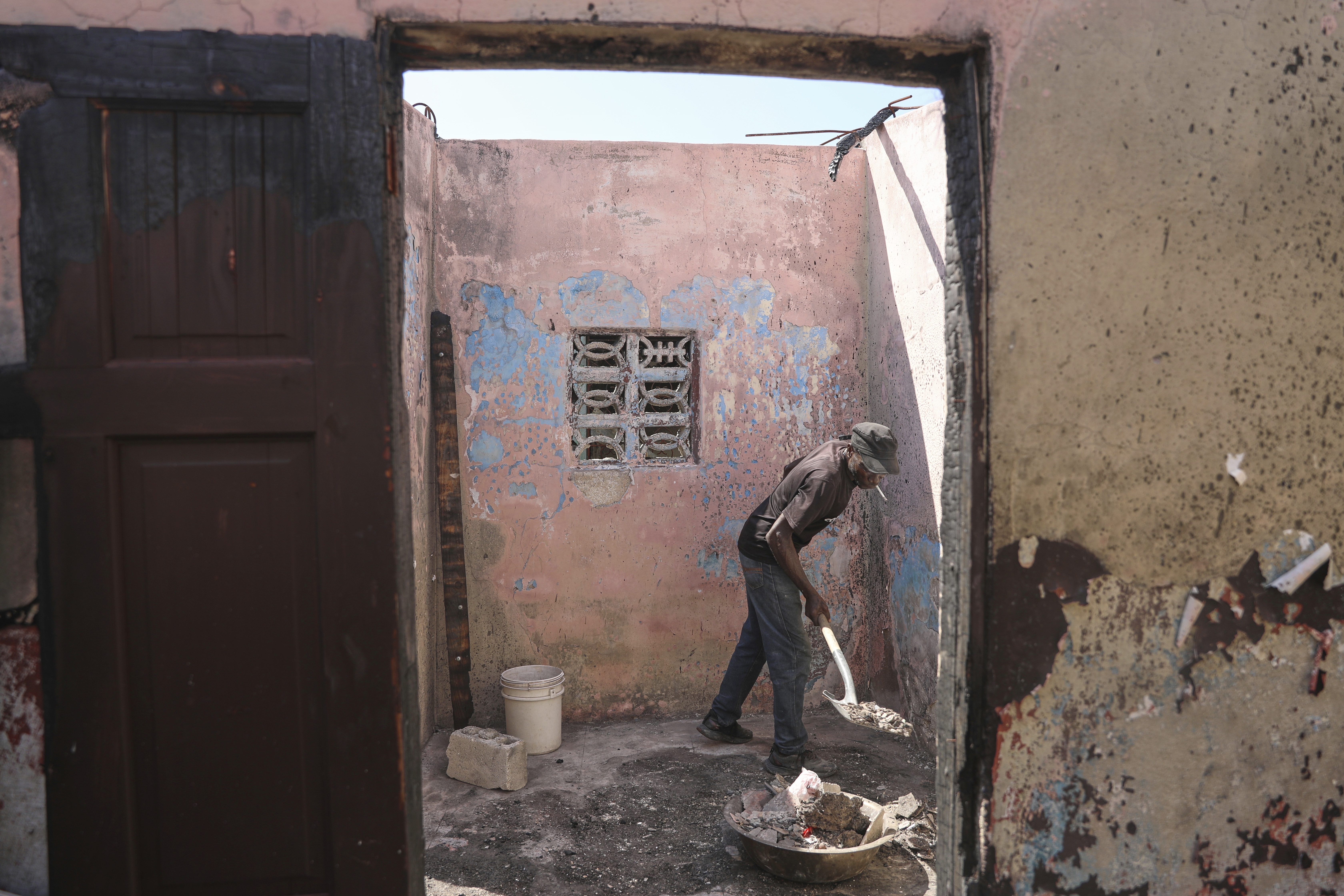 Francick Ferolis cleans his house after it was damaged by gang violence in the Solino neighborhood of Port-au-Prince, Haiti, Wednesday, Sept. 10, 2025. (Odelyn Joseph - AP)