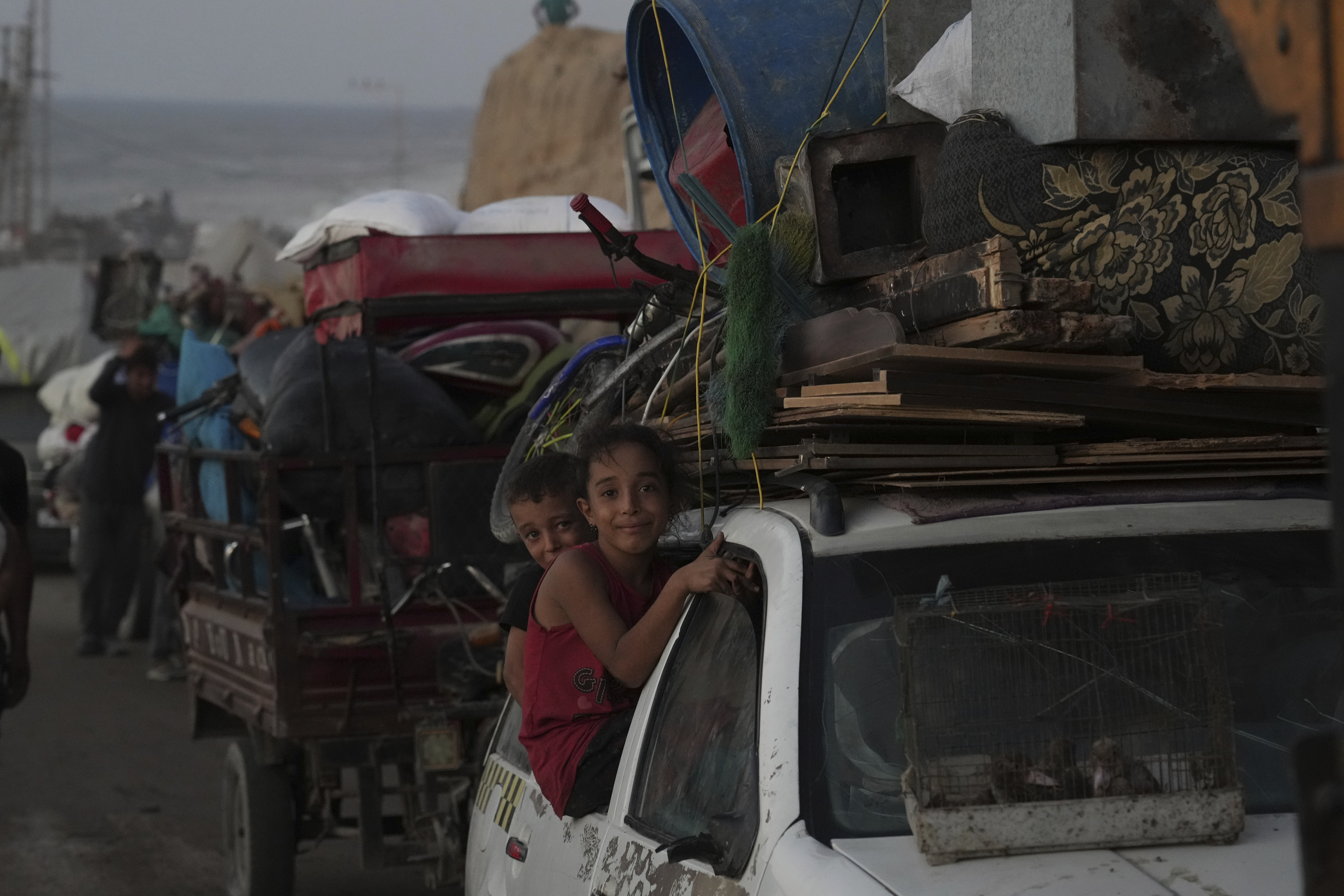 Displaced Palestinians flee Gaza City, carrying their belongings along the coastal road in Nuseirat toward the southern Gaza Strip, Friday, Sept. 19, 2025. (Abdel Kareem Hana - AP)