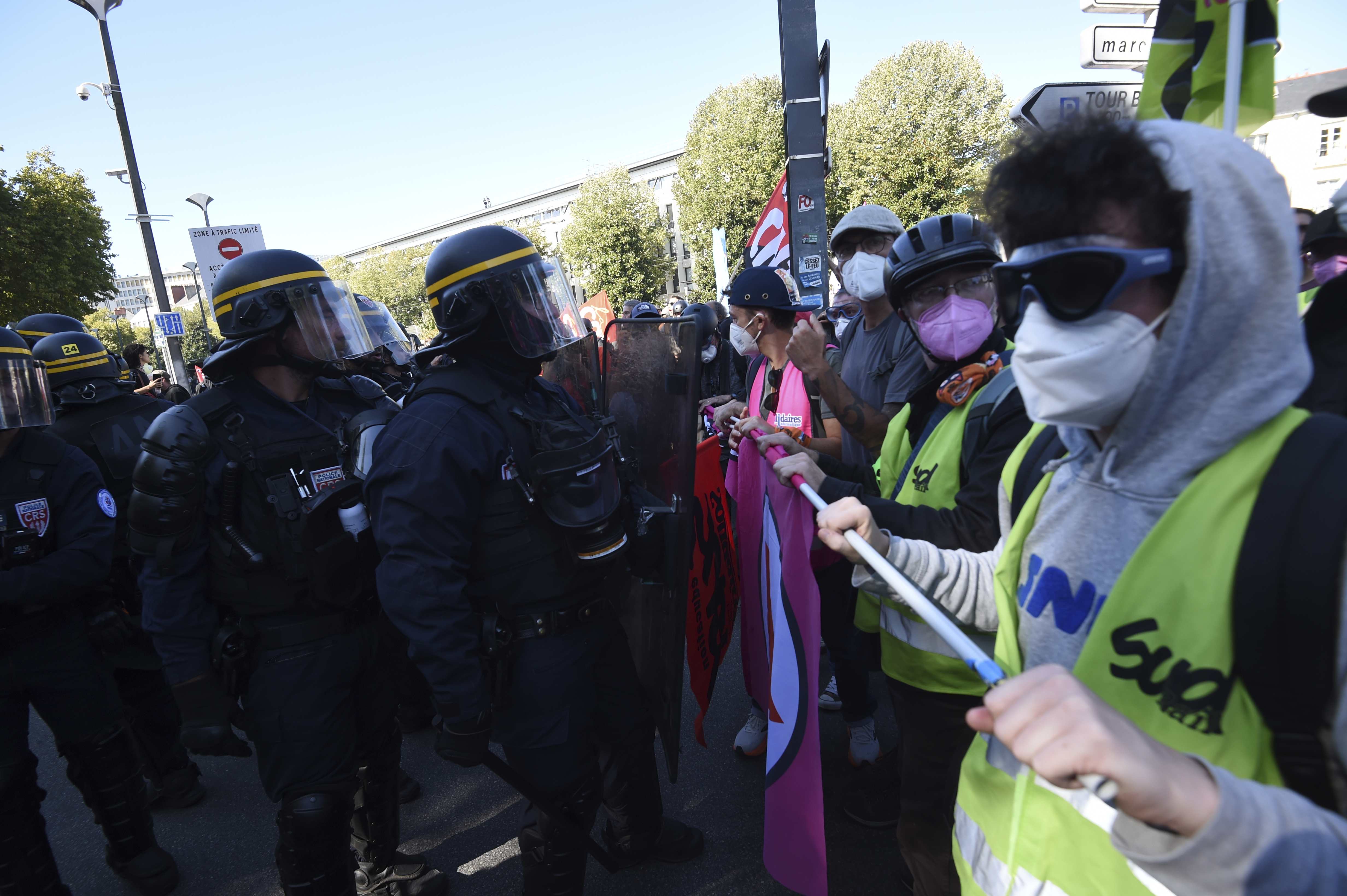 Demonstrators face police during a protest called by major trade unions to oppose budget cuts, in Nantes, western France, Thursday, Sept. 18, 2025. (Mathieu Pattier - AP)