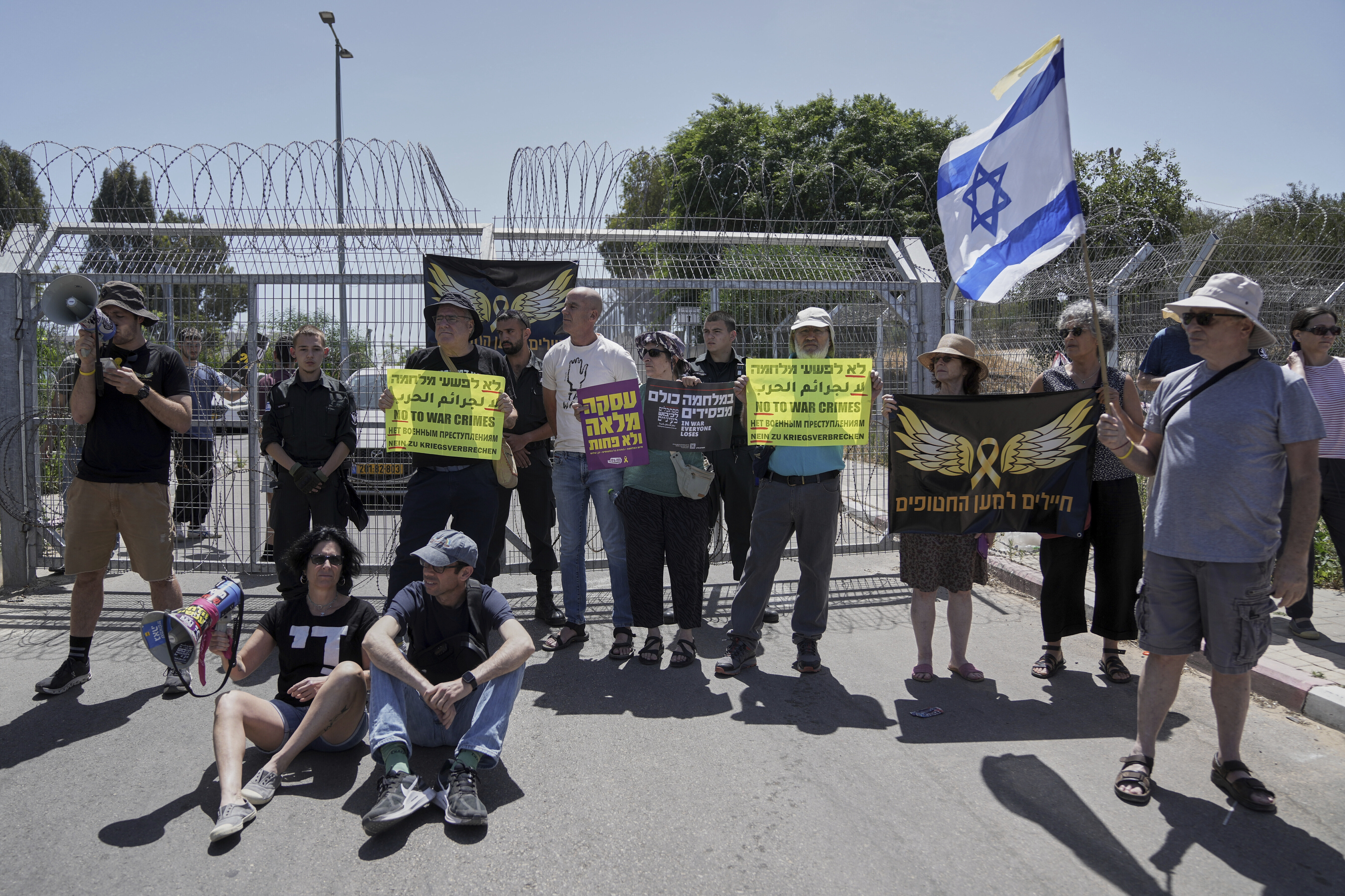 FILE - Relatives and supporters of Israeli soldier Daniel Yahalom, who was jailed for refusing to fight in Gaza, call for an end to the war outside the Beit Lid military base in central Israel on May 16, 2025. (Mahmoud Illean - AP)
