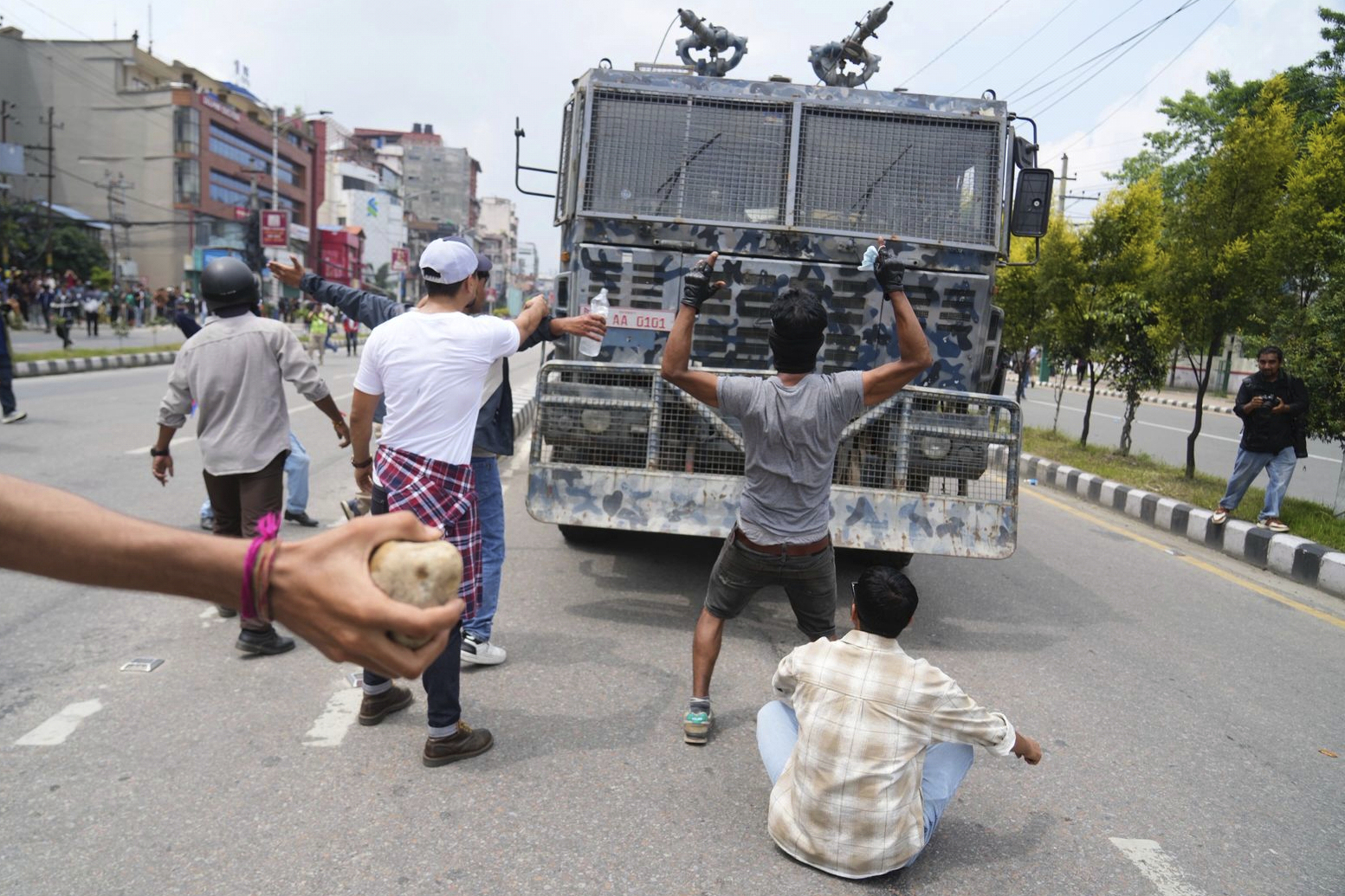 Protesters shout slogans in front of an armored vehicle outside the Parliament building in Kathmandu, Nepal, Monday, Sept. 8, 2025. (Niranjan Shrestha - AP)