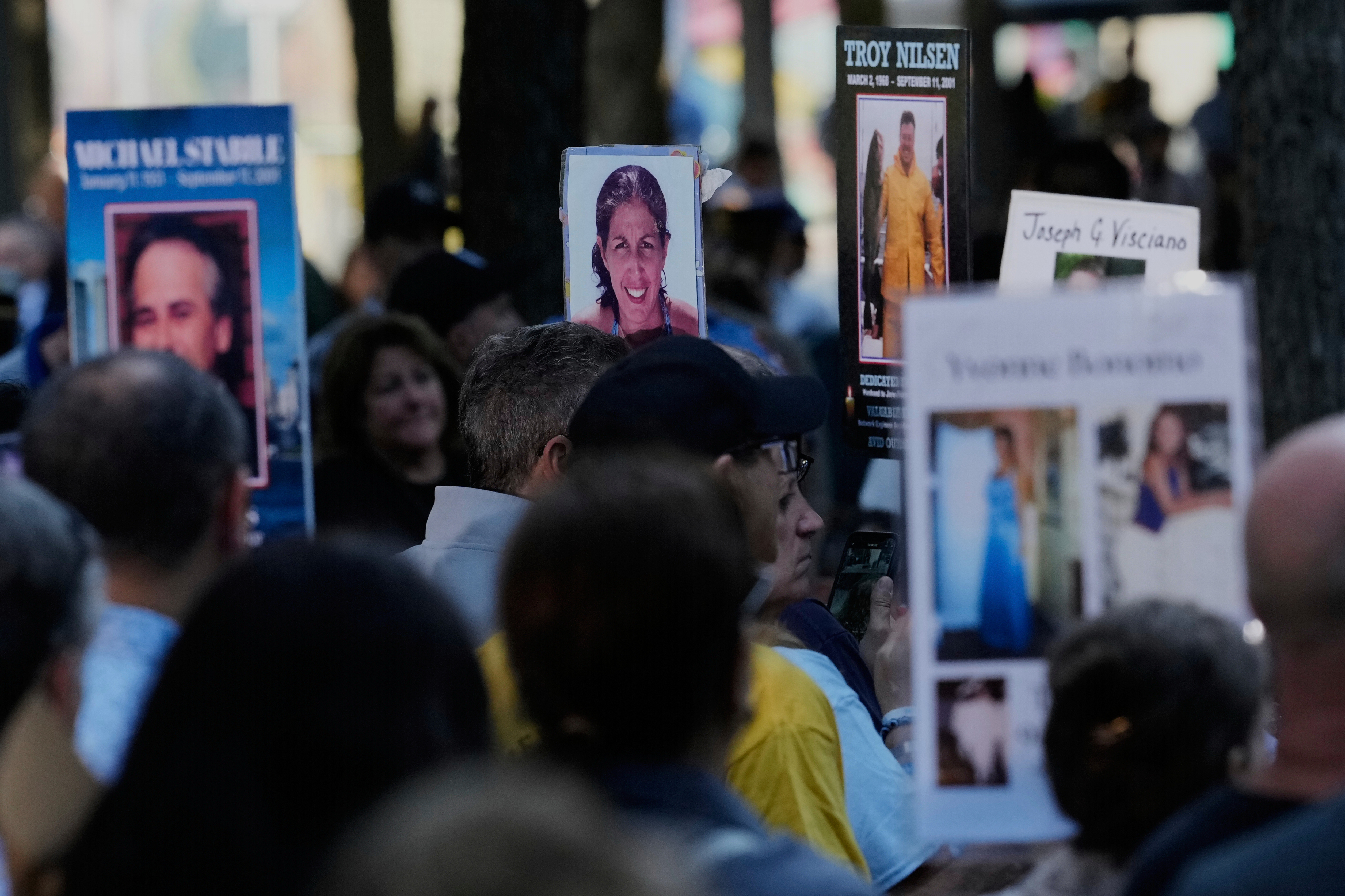 People hold up pictures of family members during a ceremony to mark the 24th anniversary of the 9/11 attacks, Thursday, Sept. 11, 2025, in New York. (Seth Wenig - AP)