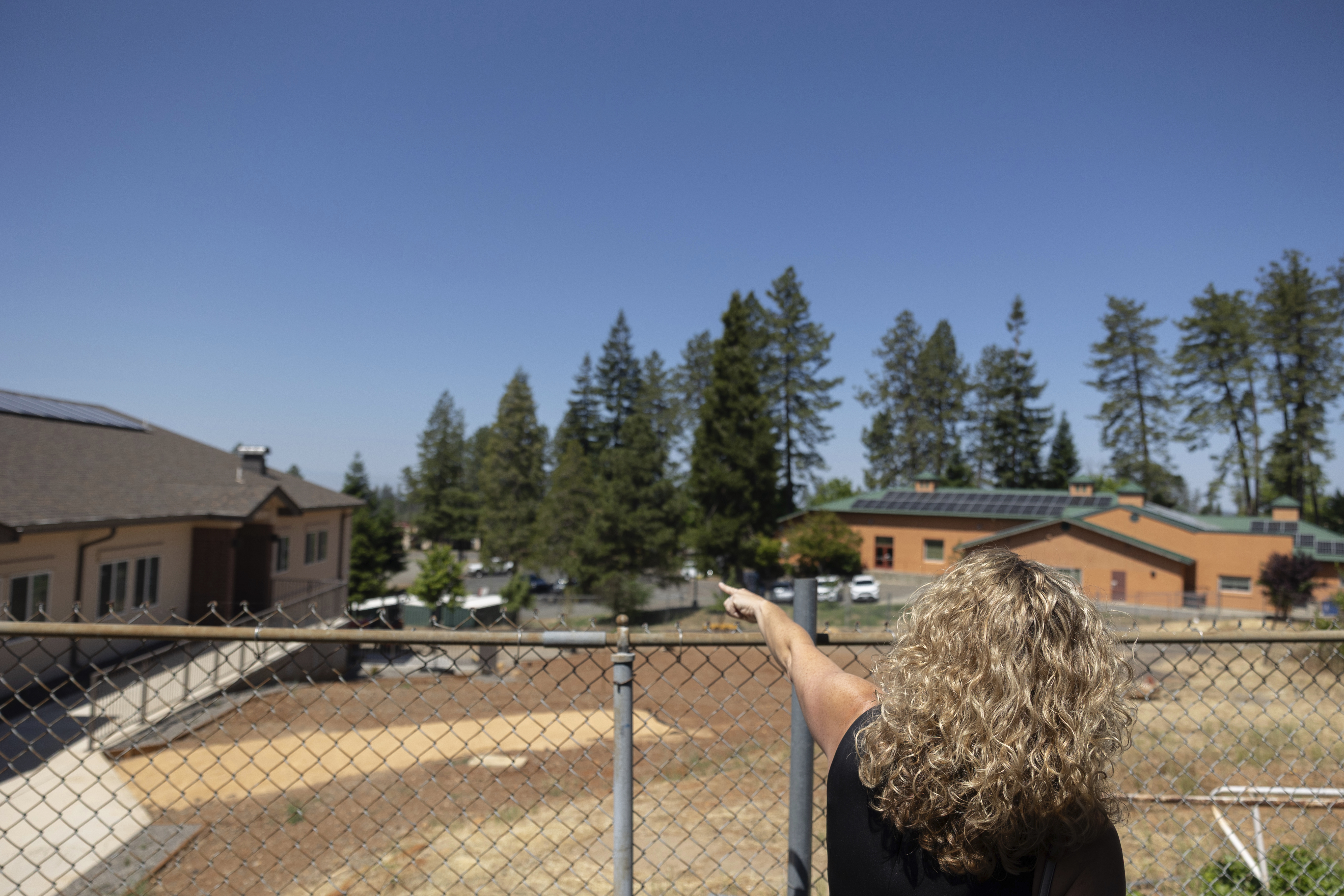 Superintendent Casey Taylor of Achieve Academy School of Paradise, points to areas near campus that were impacted by the Camp Fire in Paradise, Calif., May 21, 2025. (Miguel Gutierrez Jr. - CalMatters)