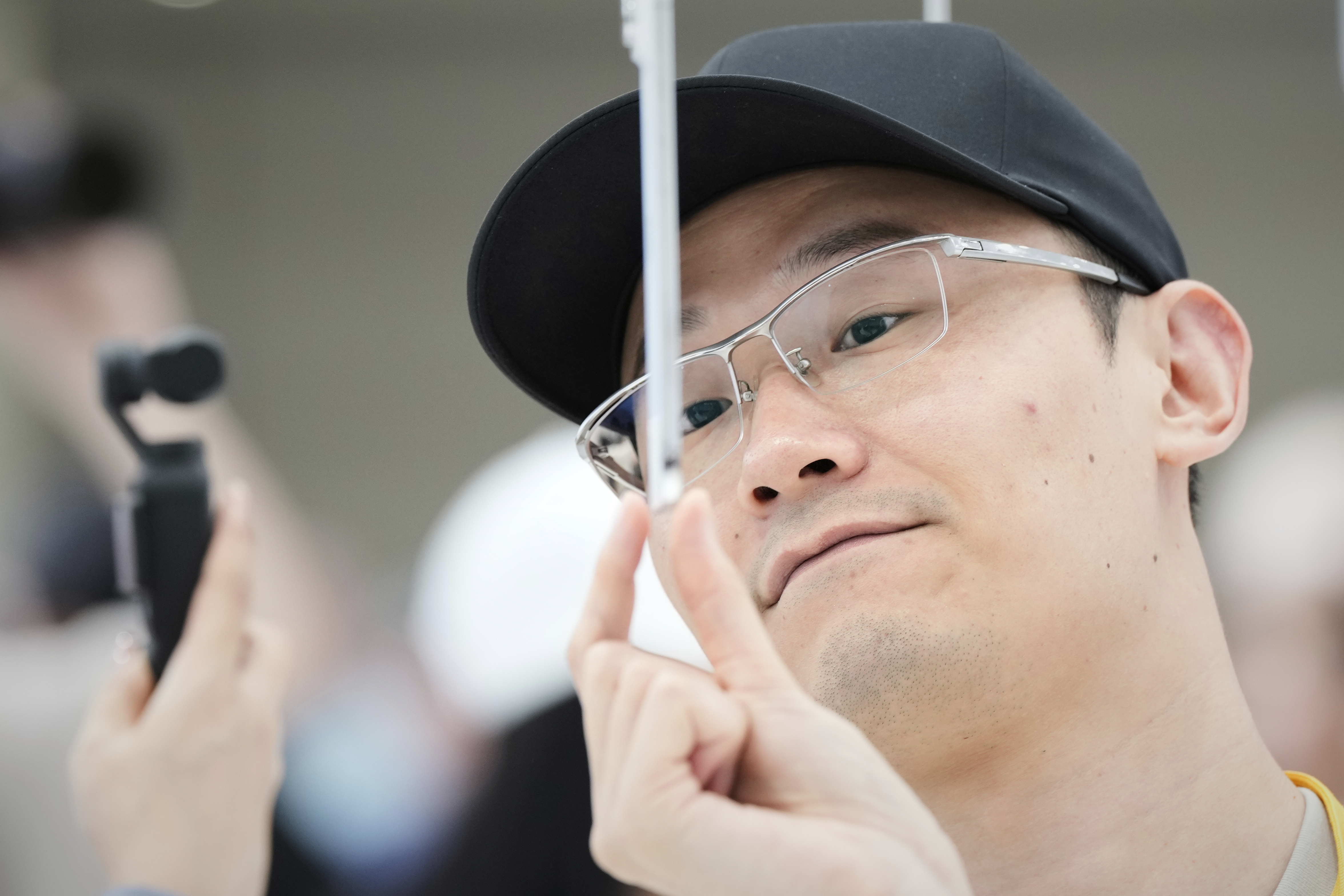 An attendee takes a closer look at the iPhone Air during an announcement of new products at Apple Park on Tuesday, Sept. 9, 2025, in Cupertino, Calif. (Godofredo A. Vásquez - AP)