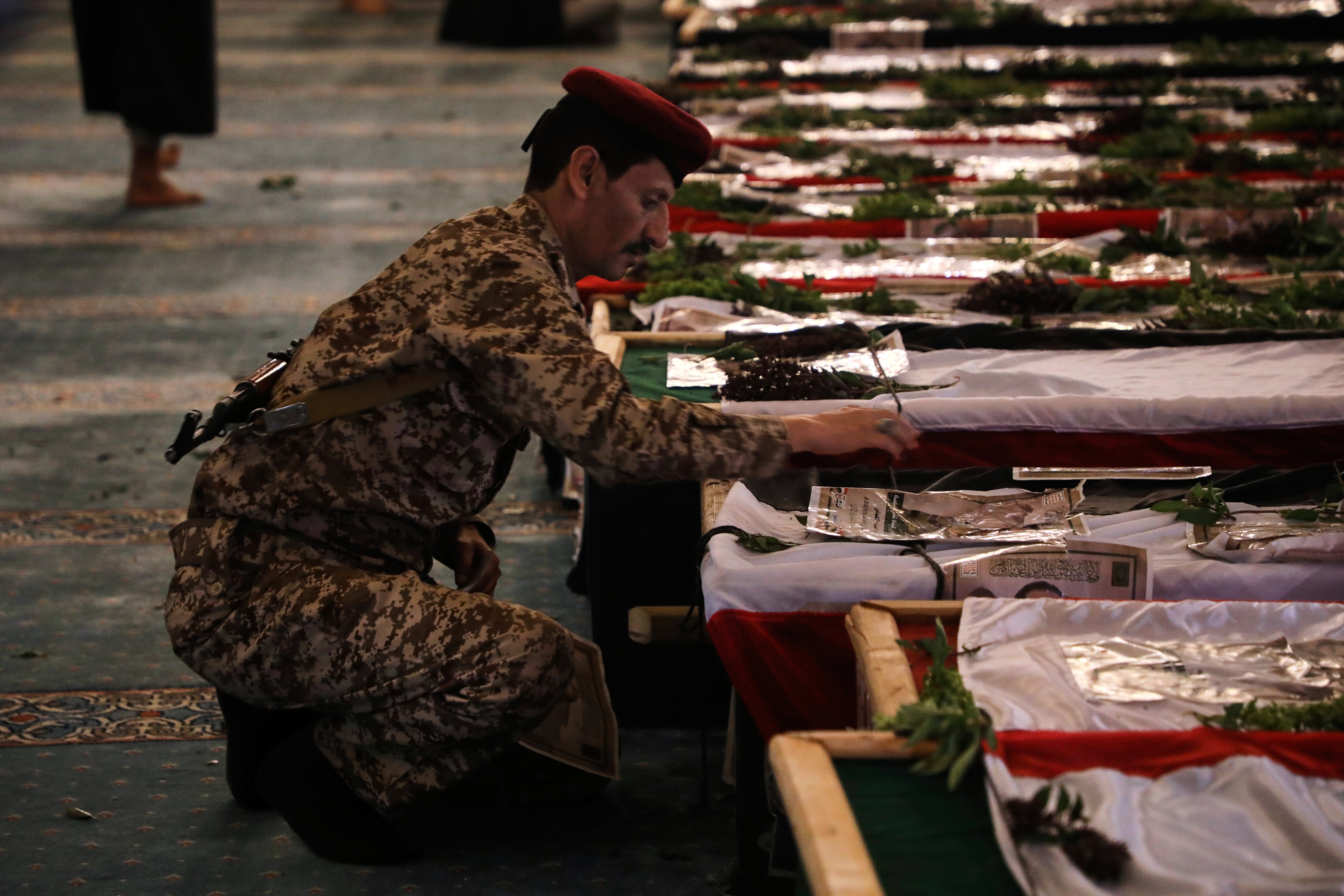 A Houthi officer mourns over a coffin of one of 31 local journalists reportedly killed in Israeli airstrikes last week, during their funeral inside the Shaab Mosque in Sanaa, Yemen, Tuesday, Sept. 16, 2025. (Osamah Abdulrahman - AP)