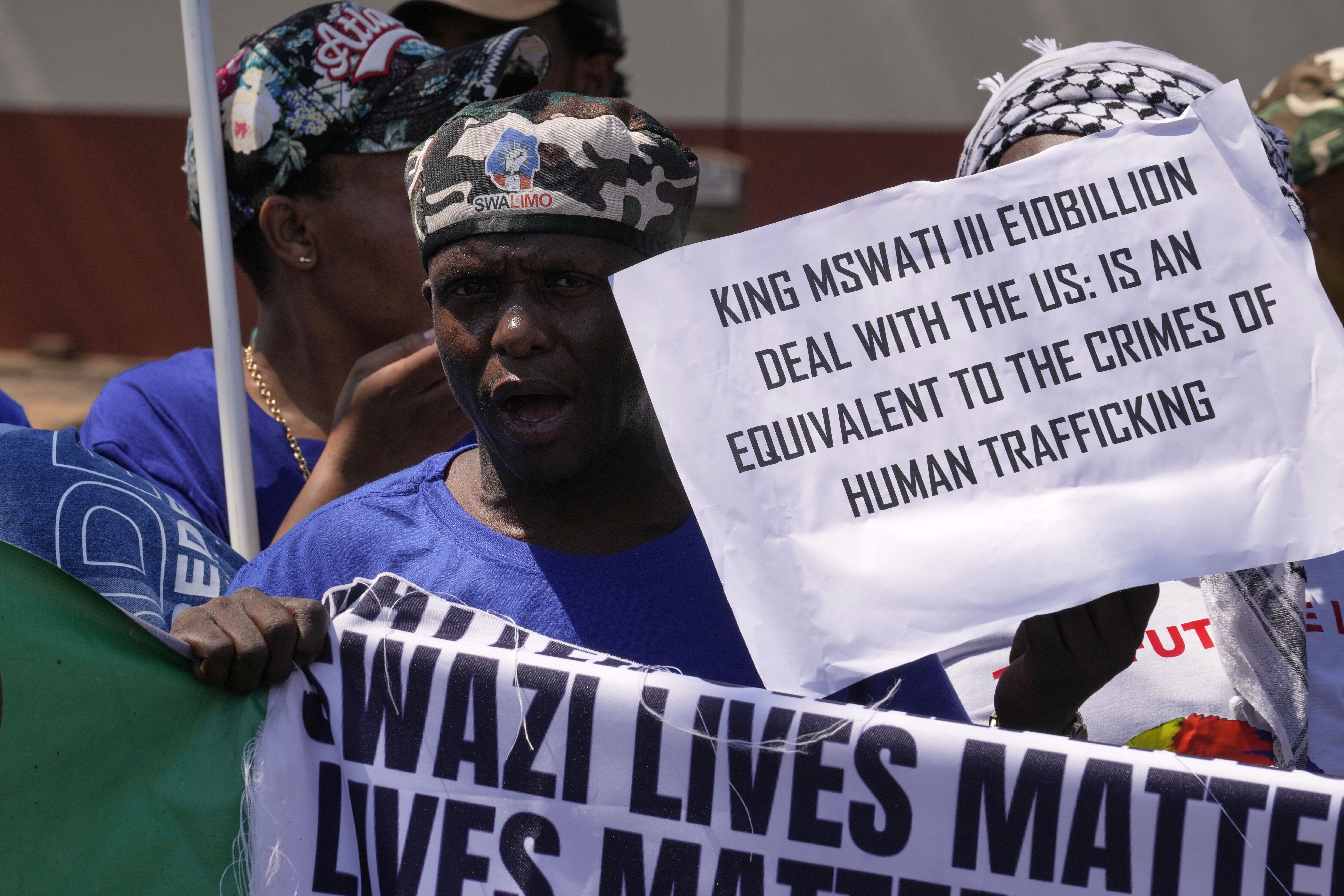 A member of Eswatin Pro-democracy activists, holds a placard at they protest outside the U.S. Embassy in Pretoria, South Africa, Friday, Sept. 19, 2025. (Themba Hadebe - AP)