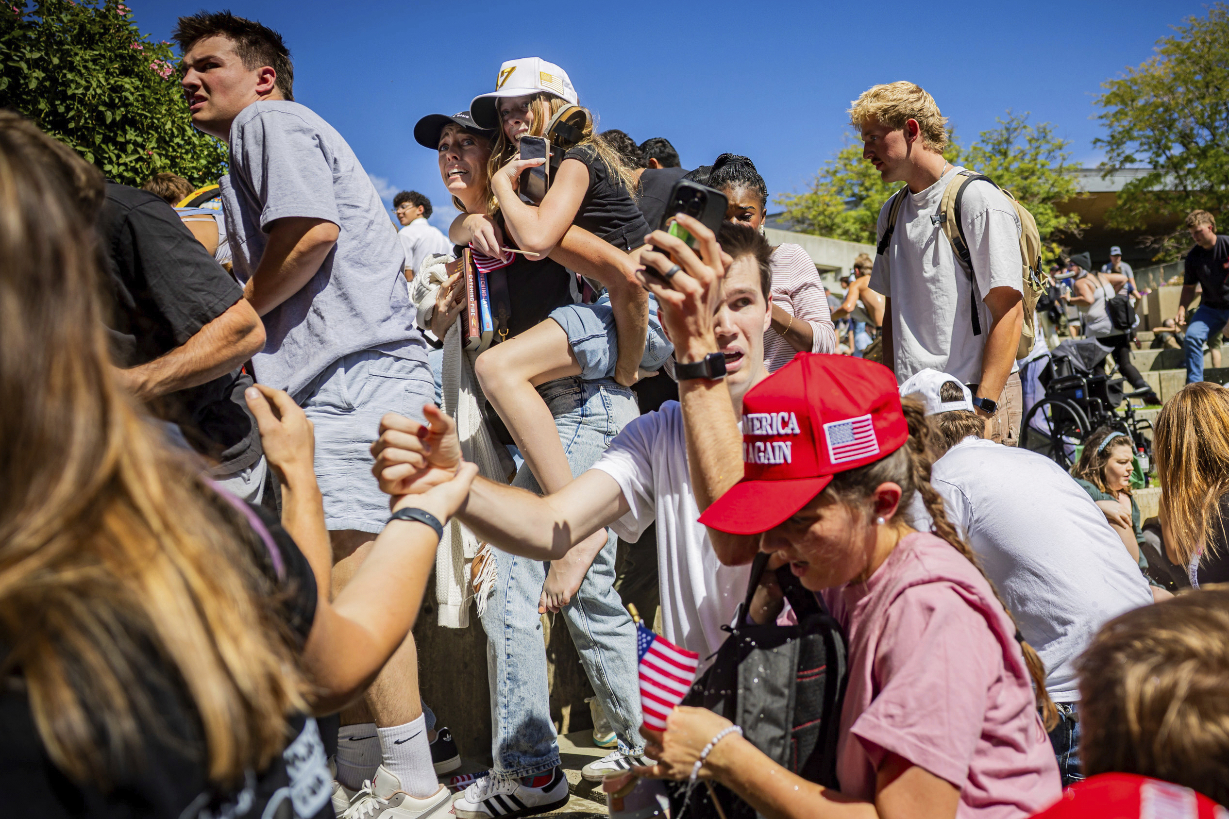 The crowd reacts after Charlie Kirk, the CEO and co-founder of the conservative youth organization Turning Point USA, is shot at the Utah Valley University Wednesday, Sept. 10, 2025, in Orem, Utah. (Tess Crowley - The Deseret News)