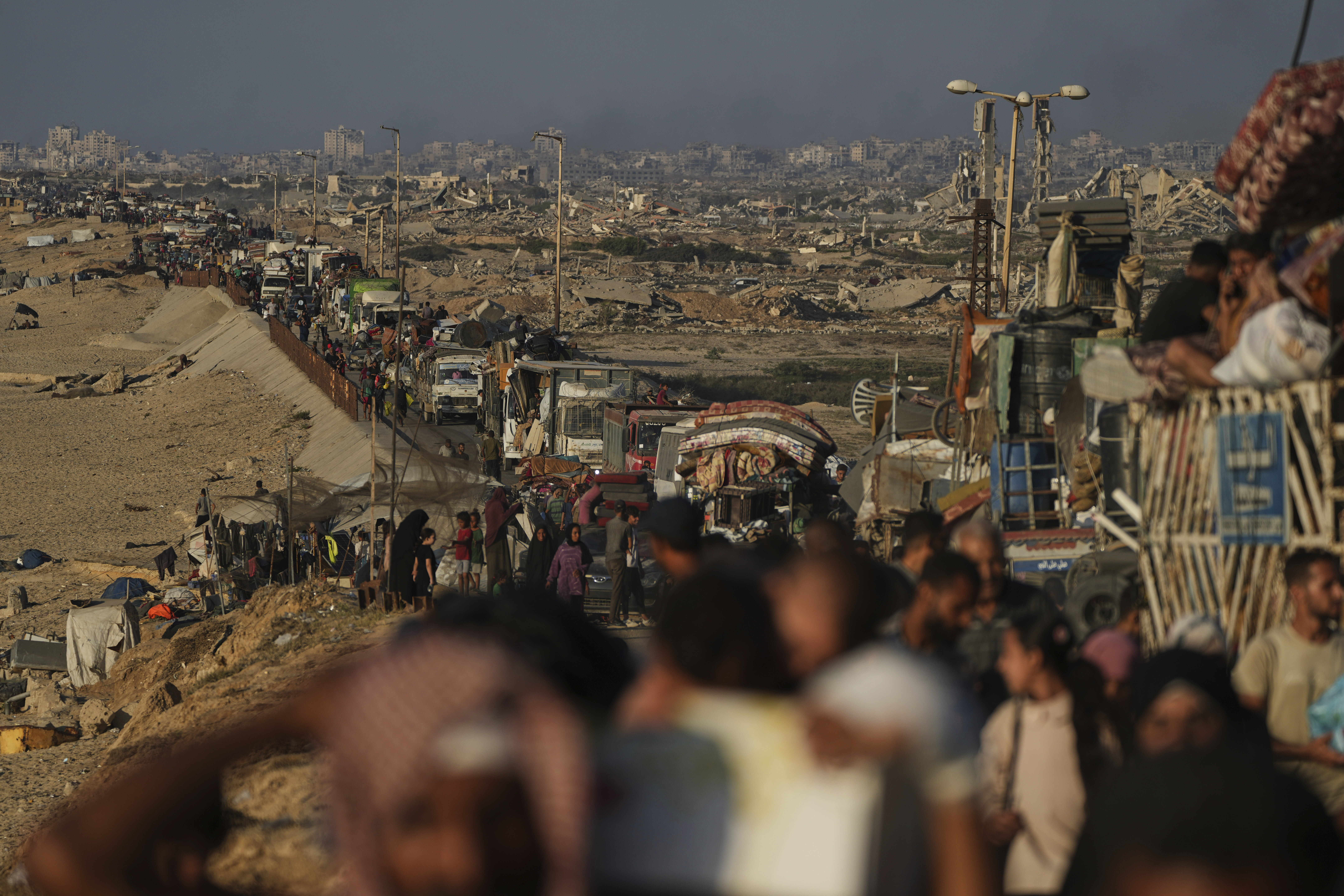 Displaced Palestinians flee northern Gaza by foot and in vehicles, carrying their belongings along the coastal road toward southern Gaza, Sunday, Sept. 14, 2025. (Abdel Kareem Hana - AP)