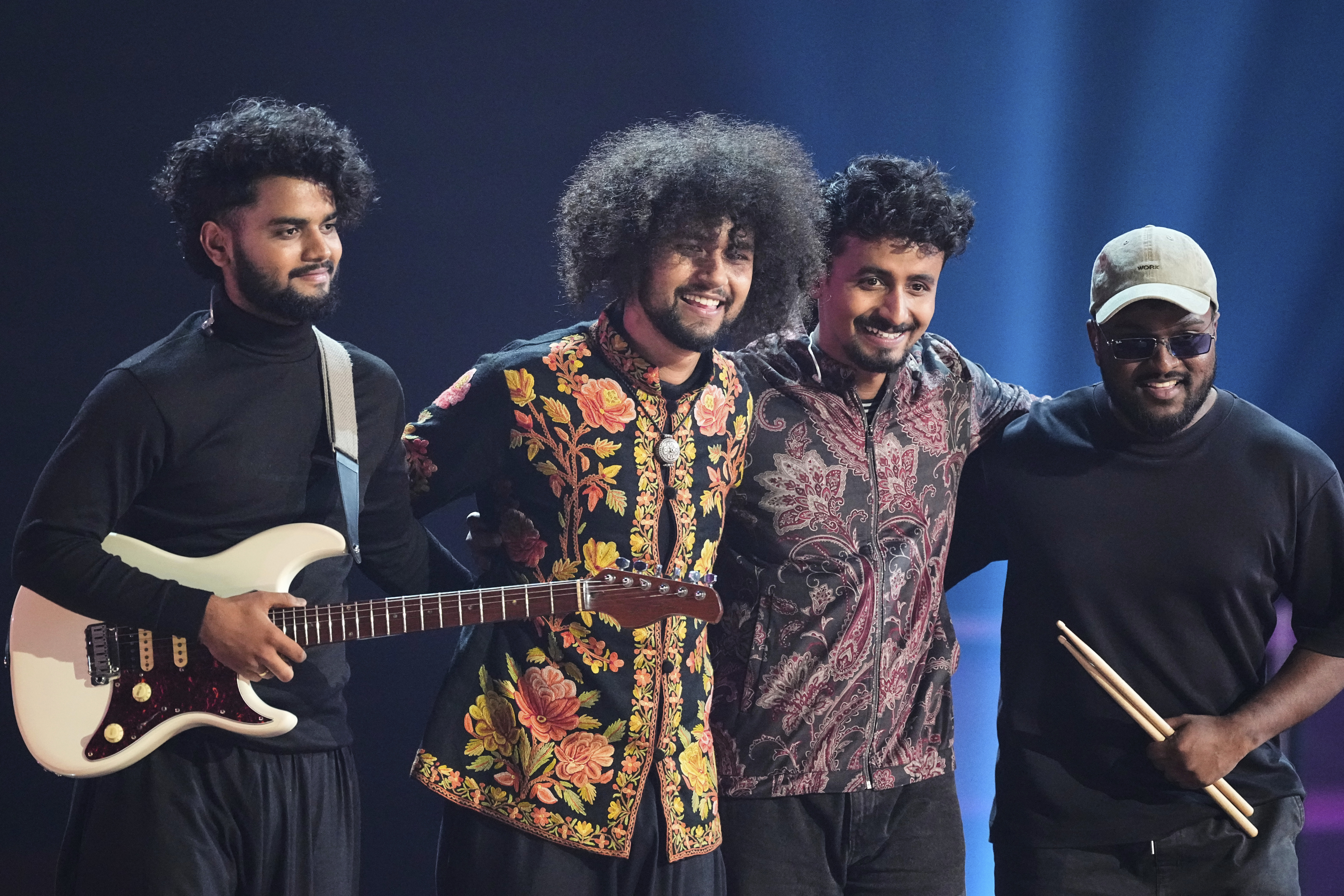 India's Rauhan Malik, 2nd left, performs the song 