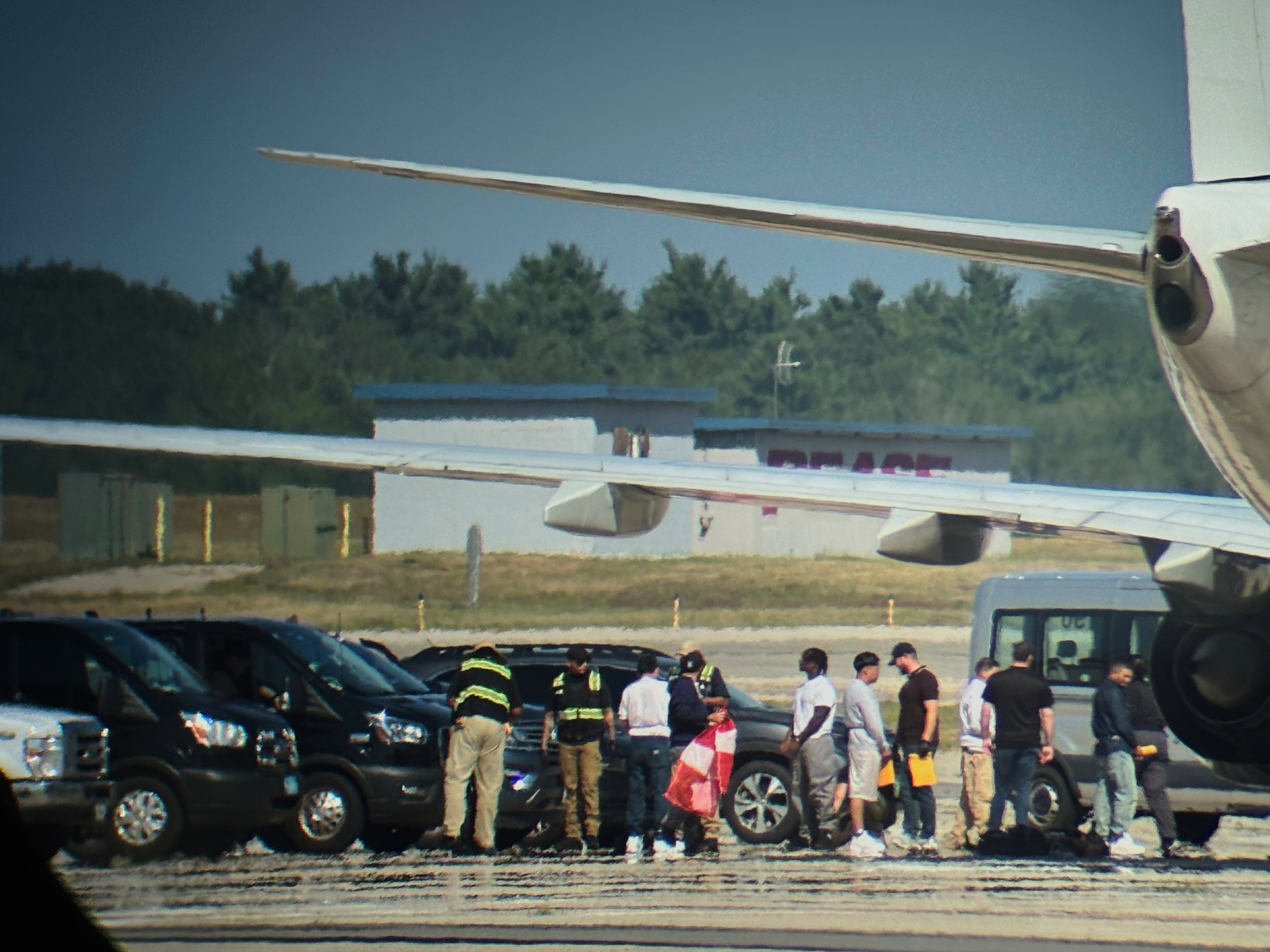 In this photo obtained by the Associated Press, ICE detainees line up to board a flight at Portsmouth International Airport at Pease, N.H., on Saturday, Aug. 16, 2025. (Uncredited - AP)